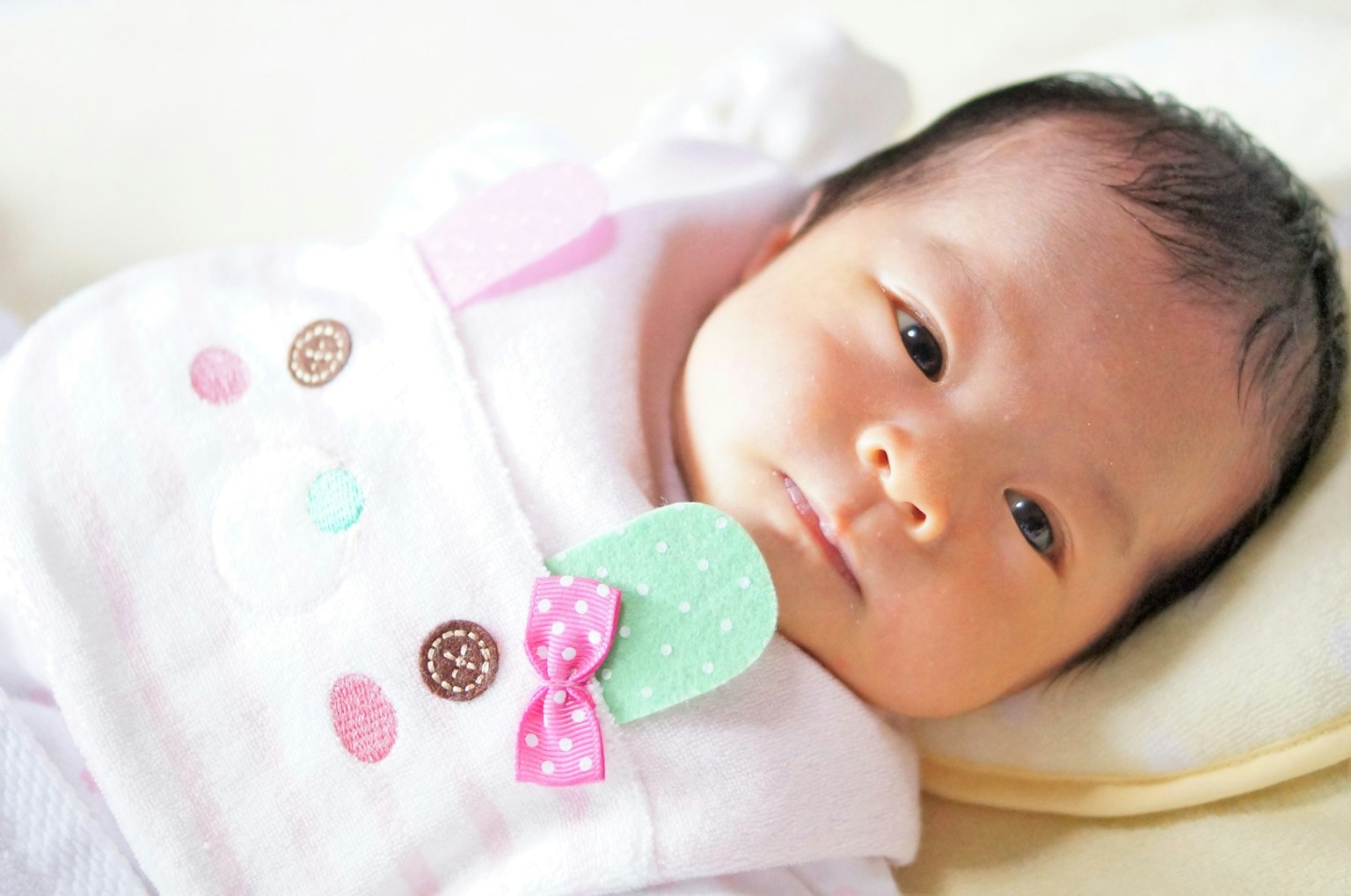 A baby wearing a cute outfit with colorful details