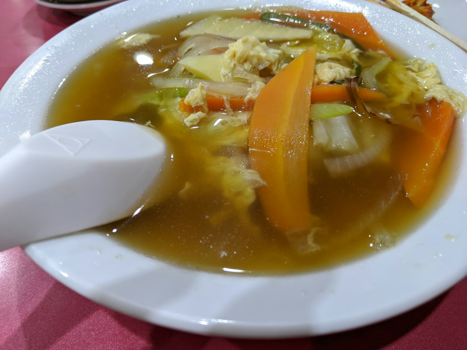 盛有多種顏色蔬菜的湯碗和湯匙