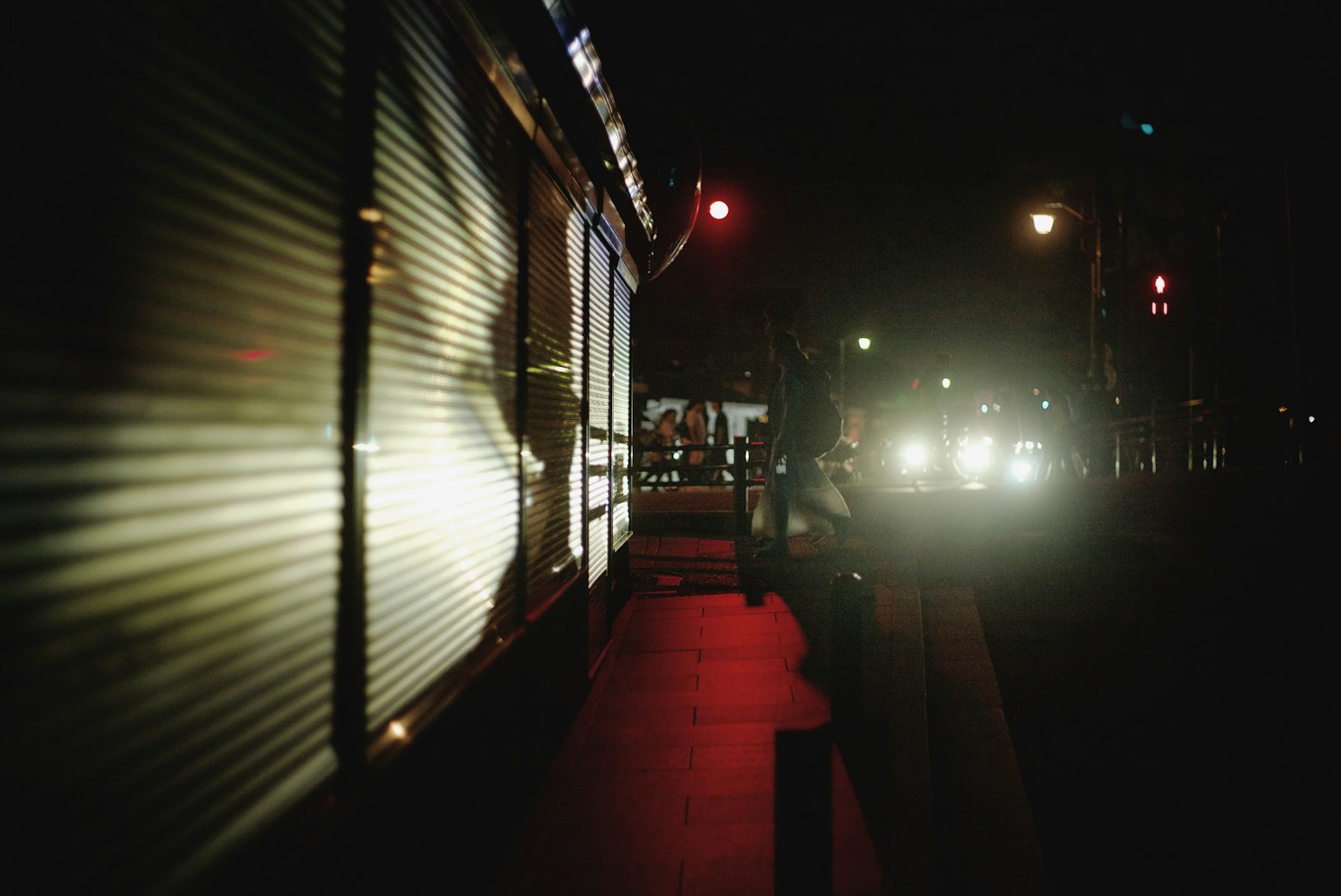 Nächtliche Straßenszene mit beleuchteten Ampeln und Autoscheinwerfern