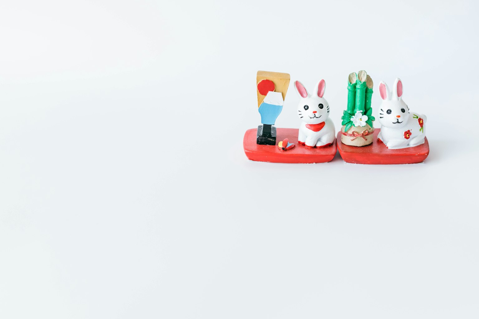 Colorful rabbit figurines arranged on a white background