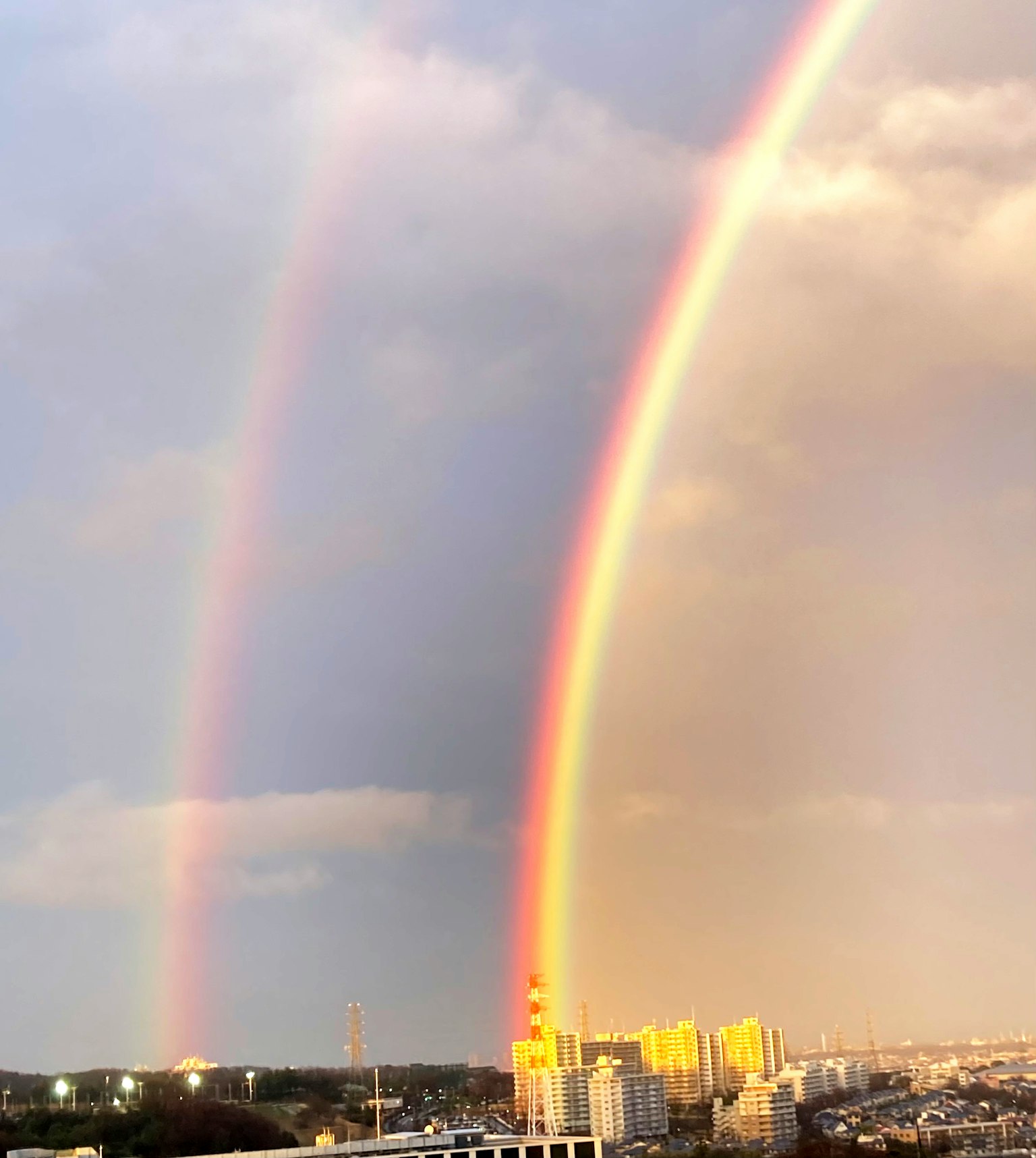 Doppio arcobaleno su uno skyline urbano
