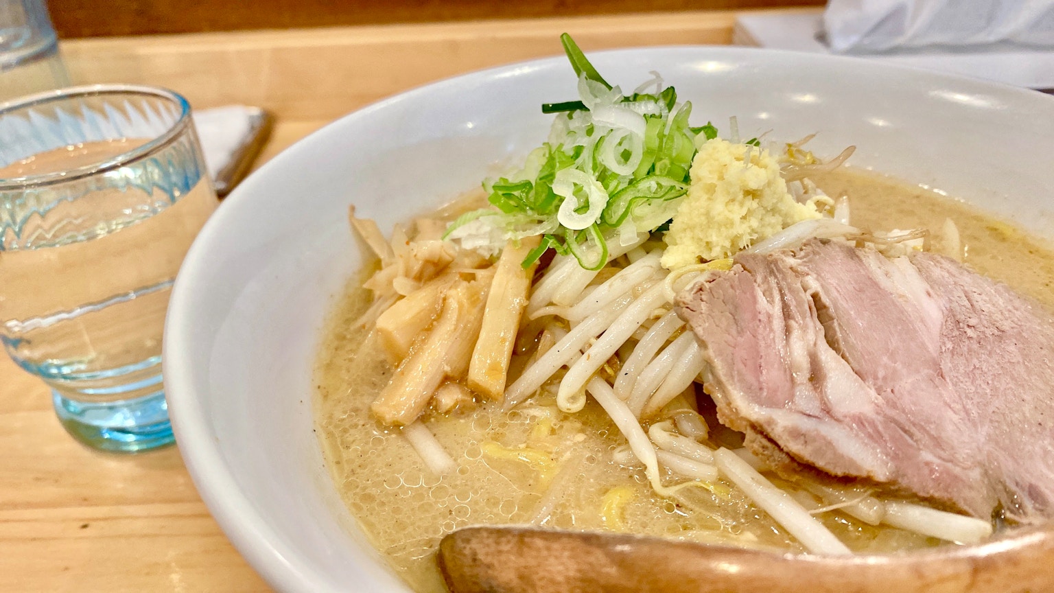 Bowl of ramen with sliced pork and vegetable toppings