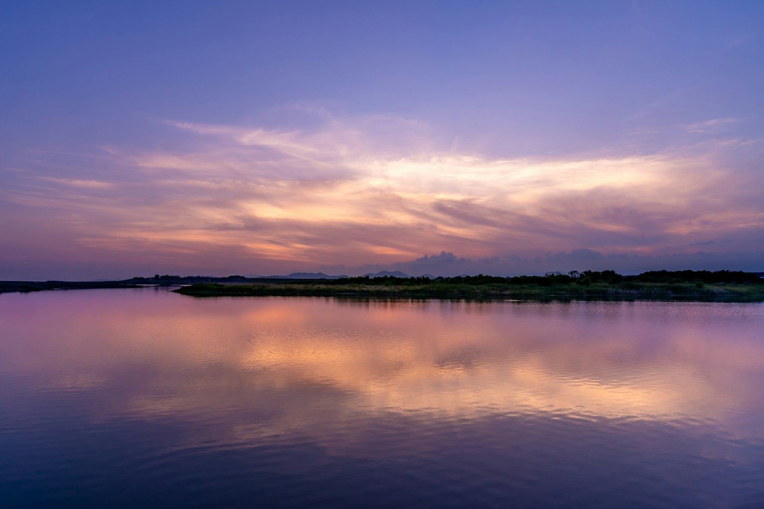 Beautiful sunset sky reflected on calm water