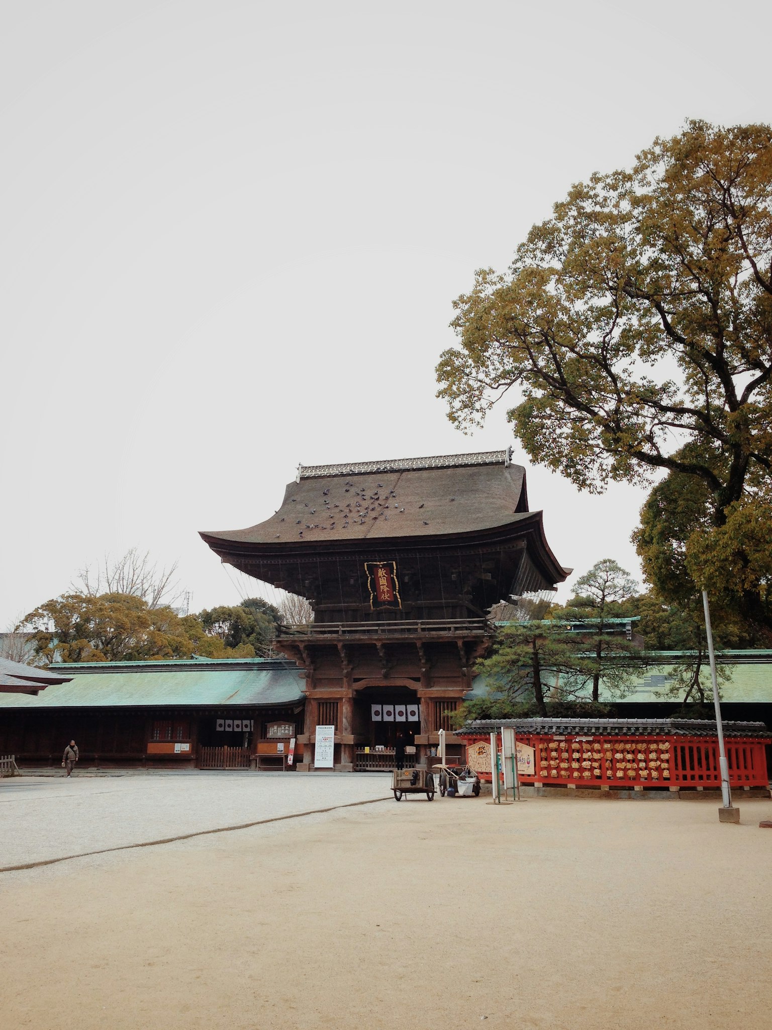 Historic temple building with a spacious courtyard surrounded by greenery