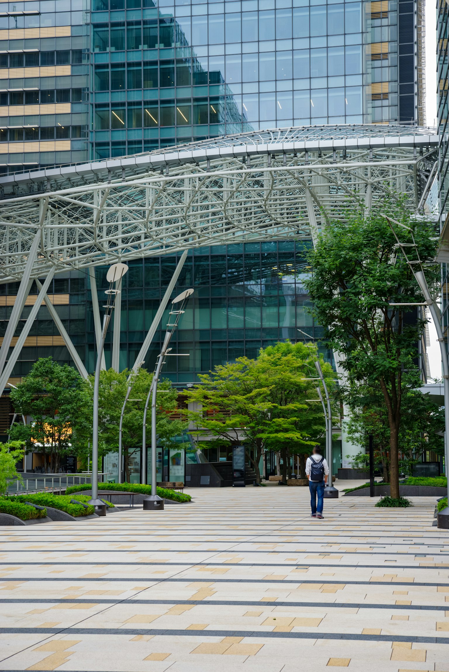 Urban landscape featuring modern buildings and an arching roof structure