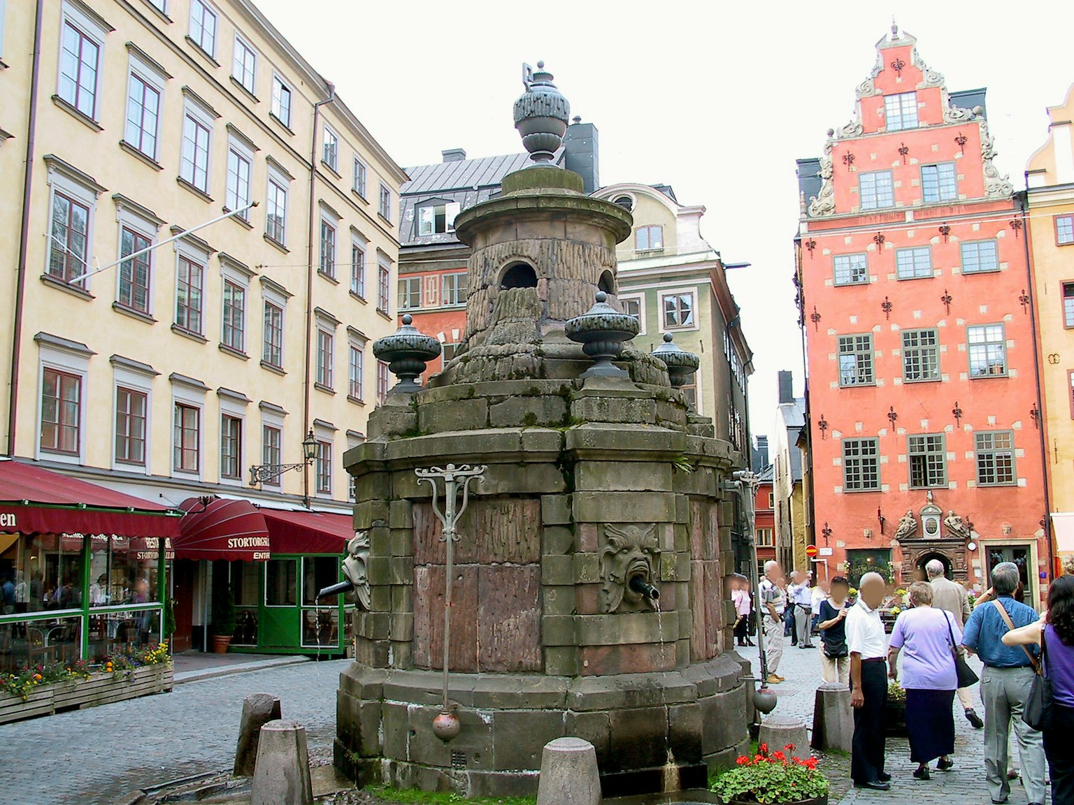 Historic fountain in Gamla Stan Stockholm with colorful buildings