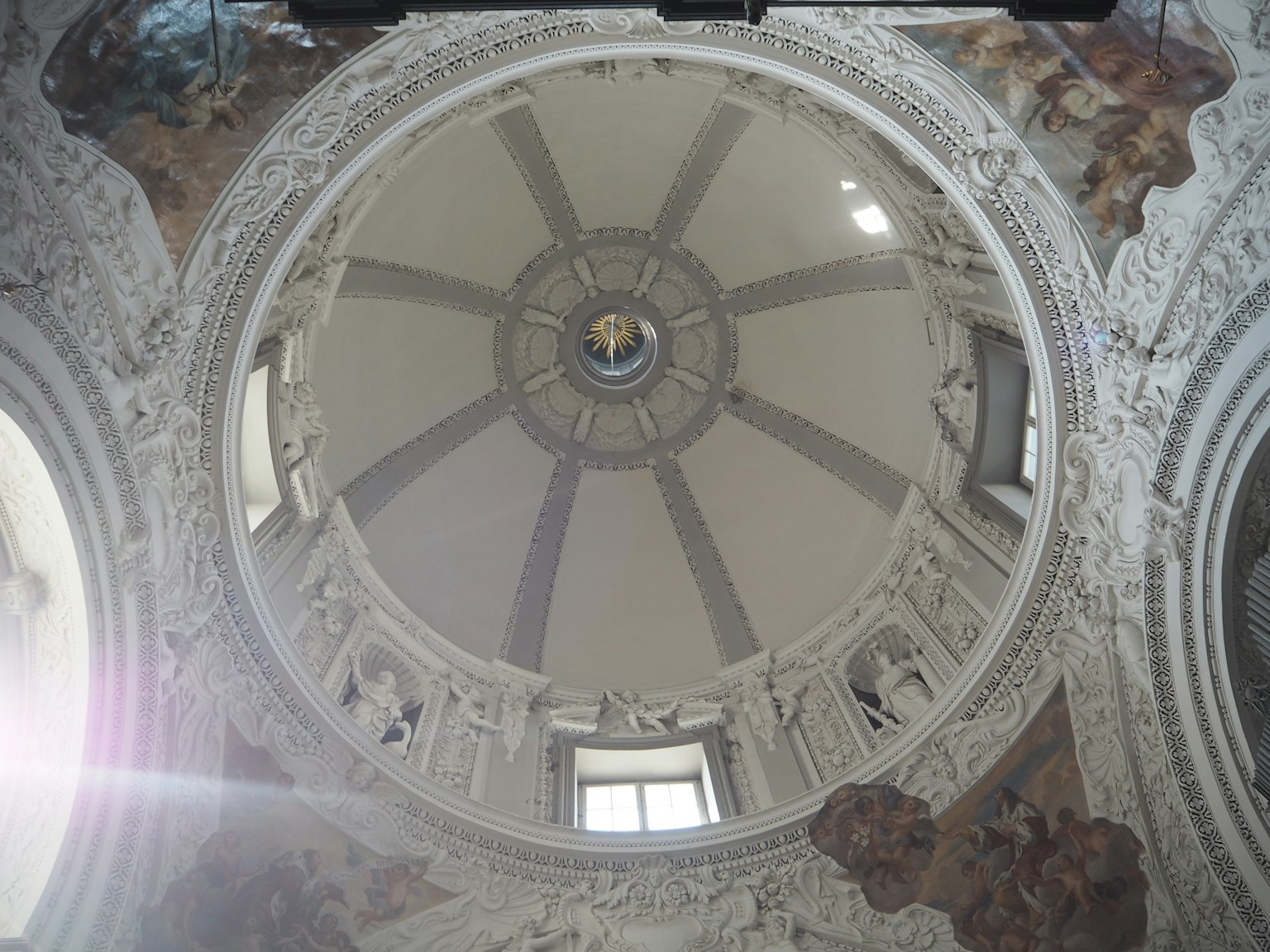View of ornate dome ceiling featuring sculptures and frescoes