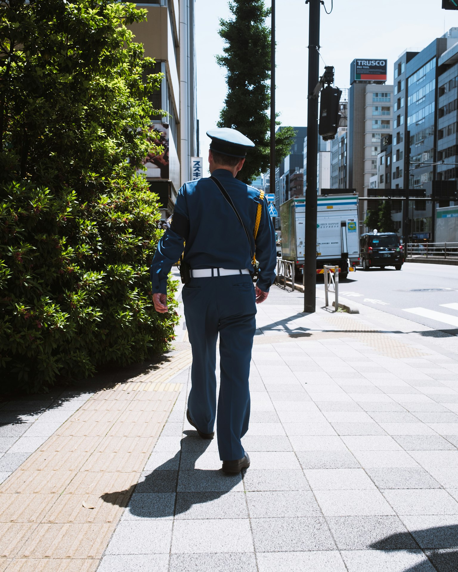 Un policier en uniforme bleu marchant dans la rue