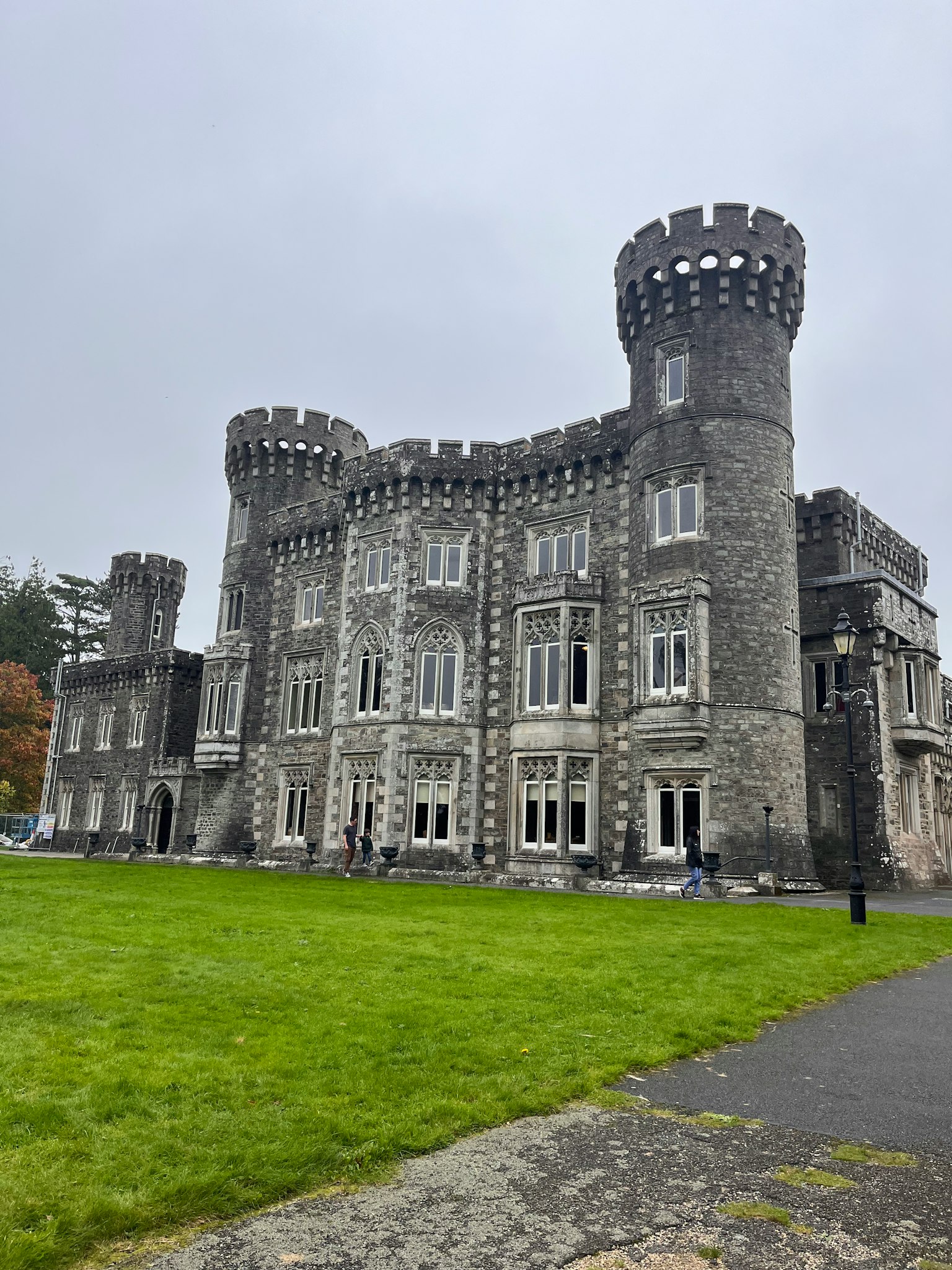 Gray stone castle with distinctive towers large windows and expansive exterior