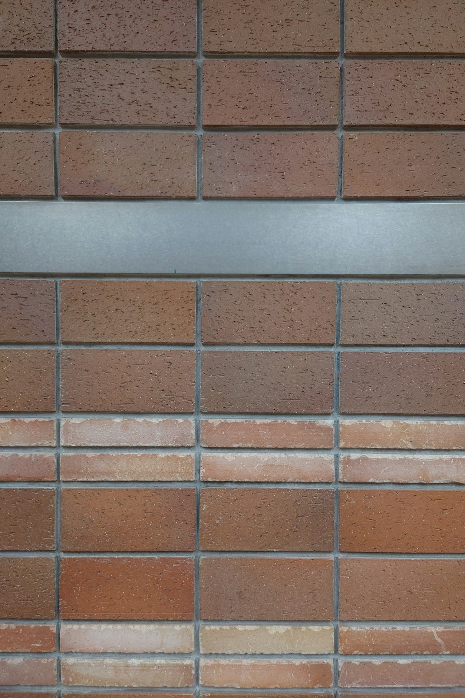 Desain dinding bata dengan strip logam horizontal