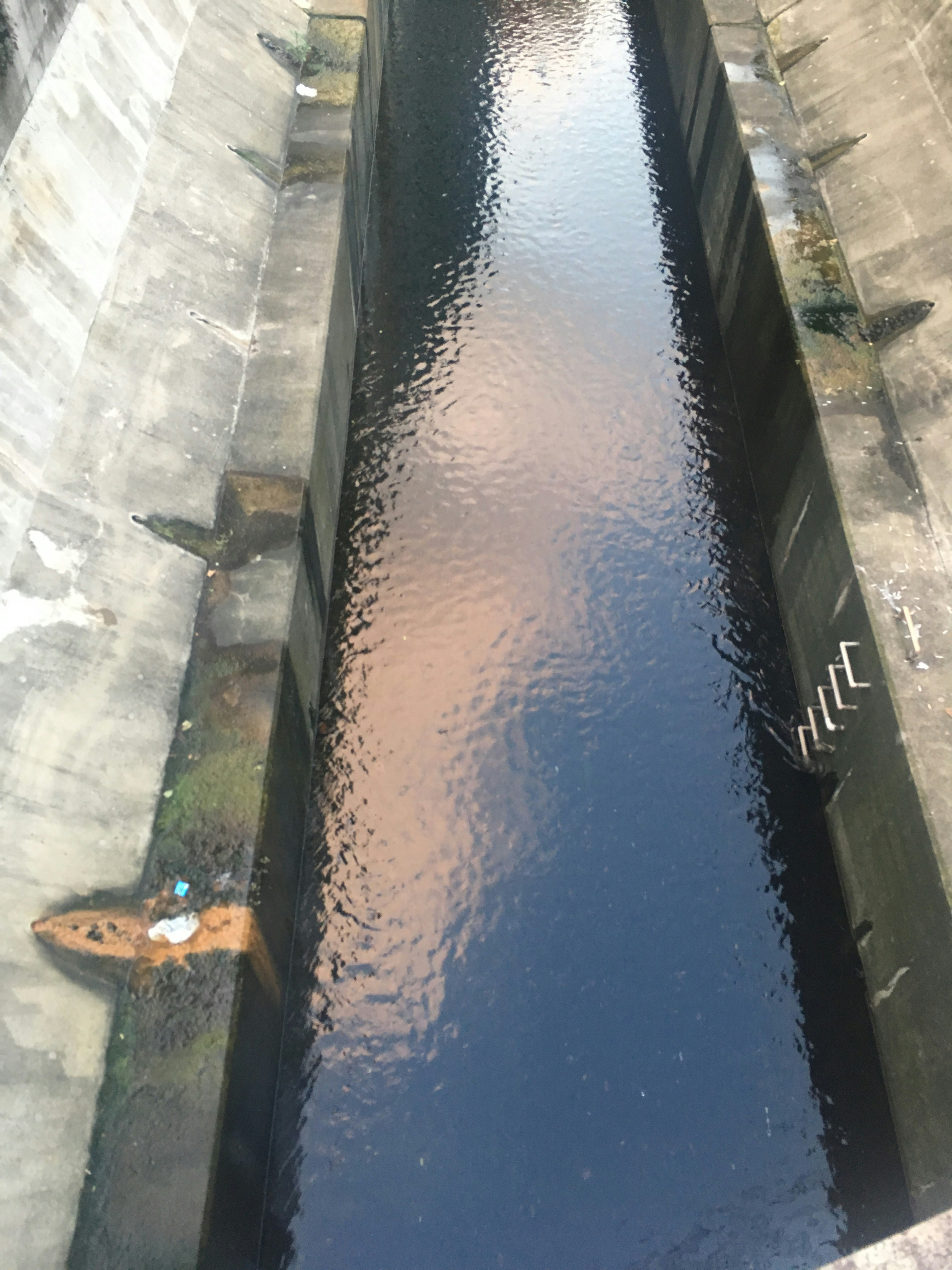 water channel with flowing water in a stone-lined trough
