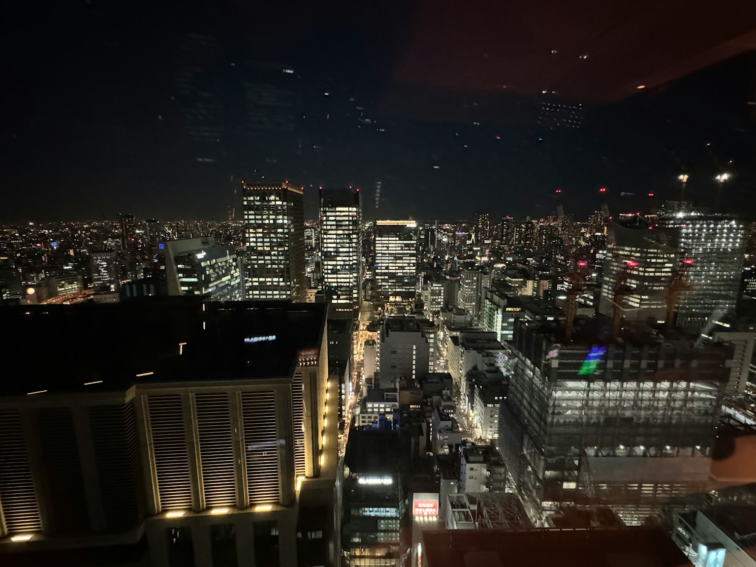 View of Tokyo's skyline at night from a high-rise building