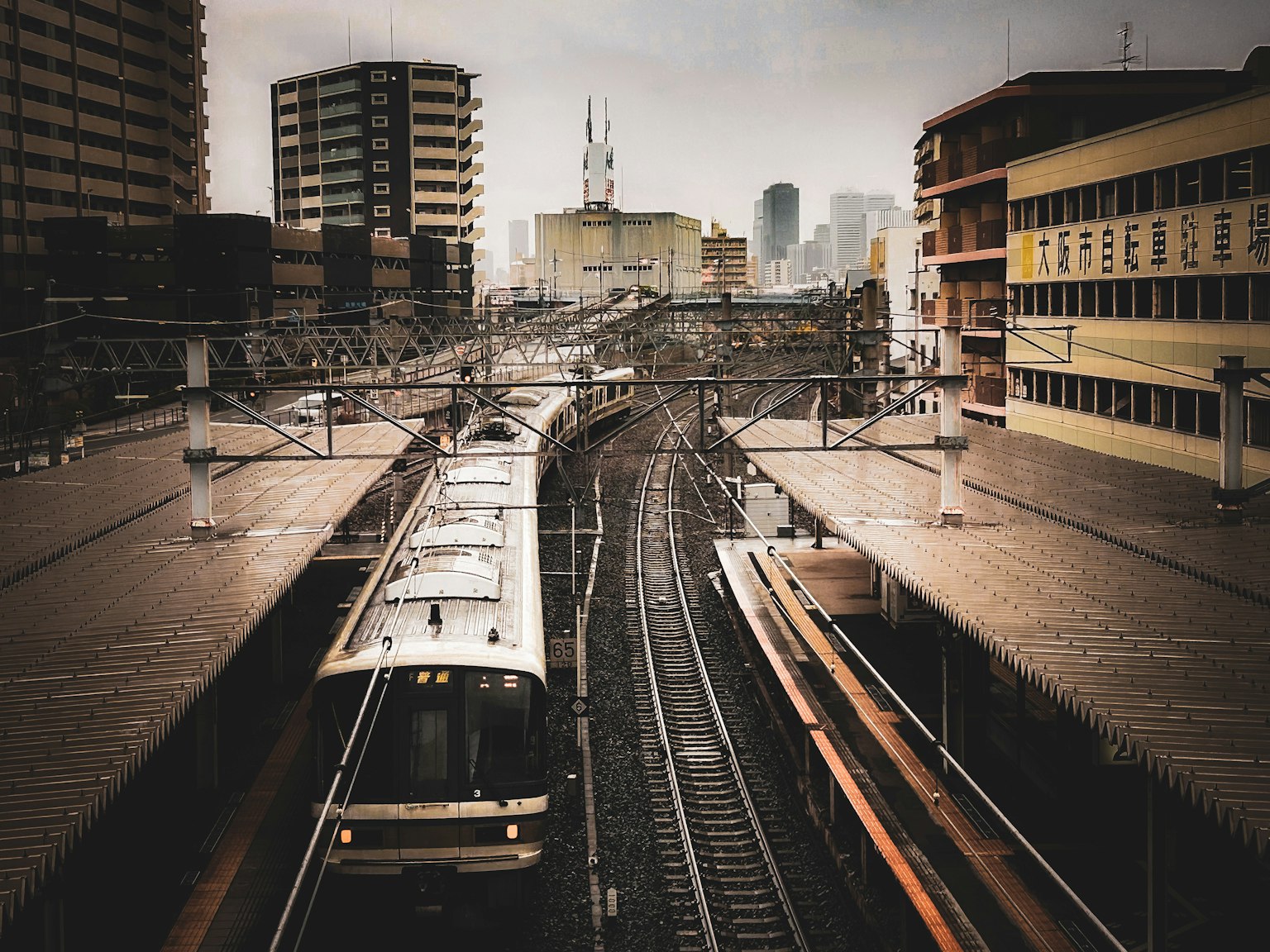 Urban train station scene featuring tracks and trains