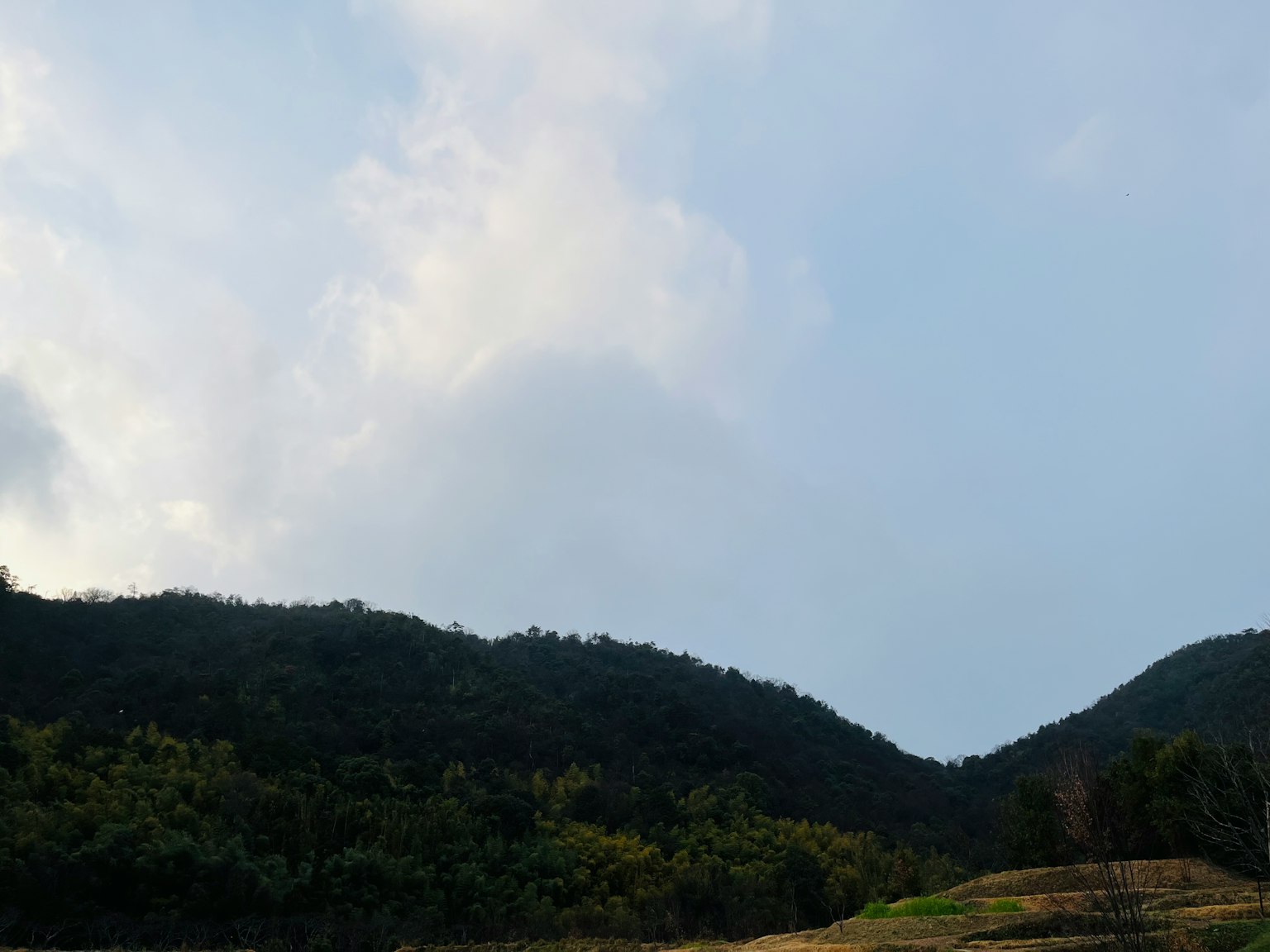 Scenic view of green mountains under a blue sky