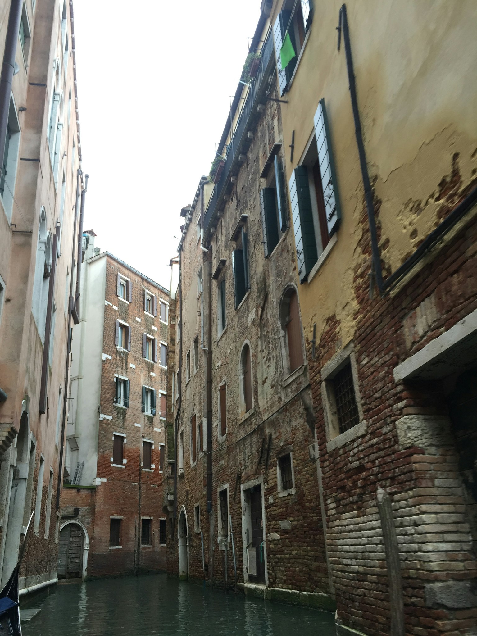 Narrow canal street with old buildings in Venice