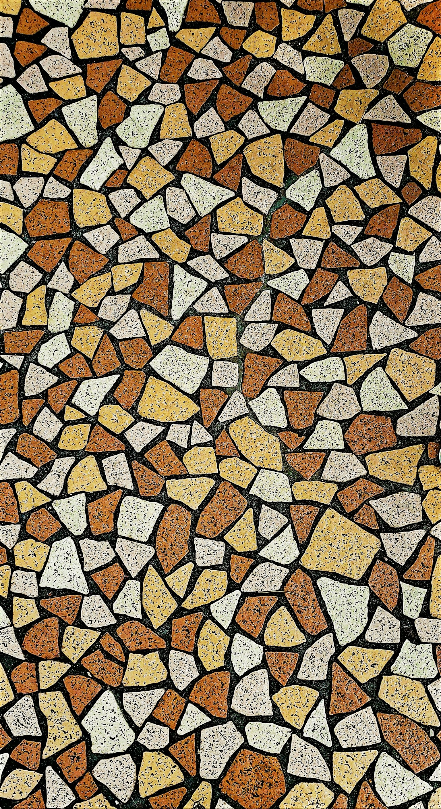 Mosaic floor made of colorful stones arranged in unique patterns
