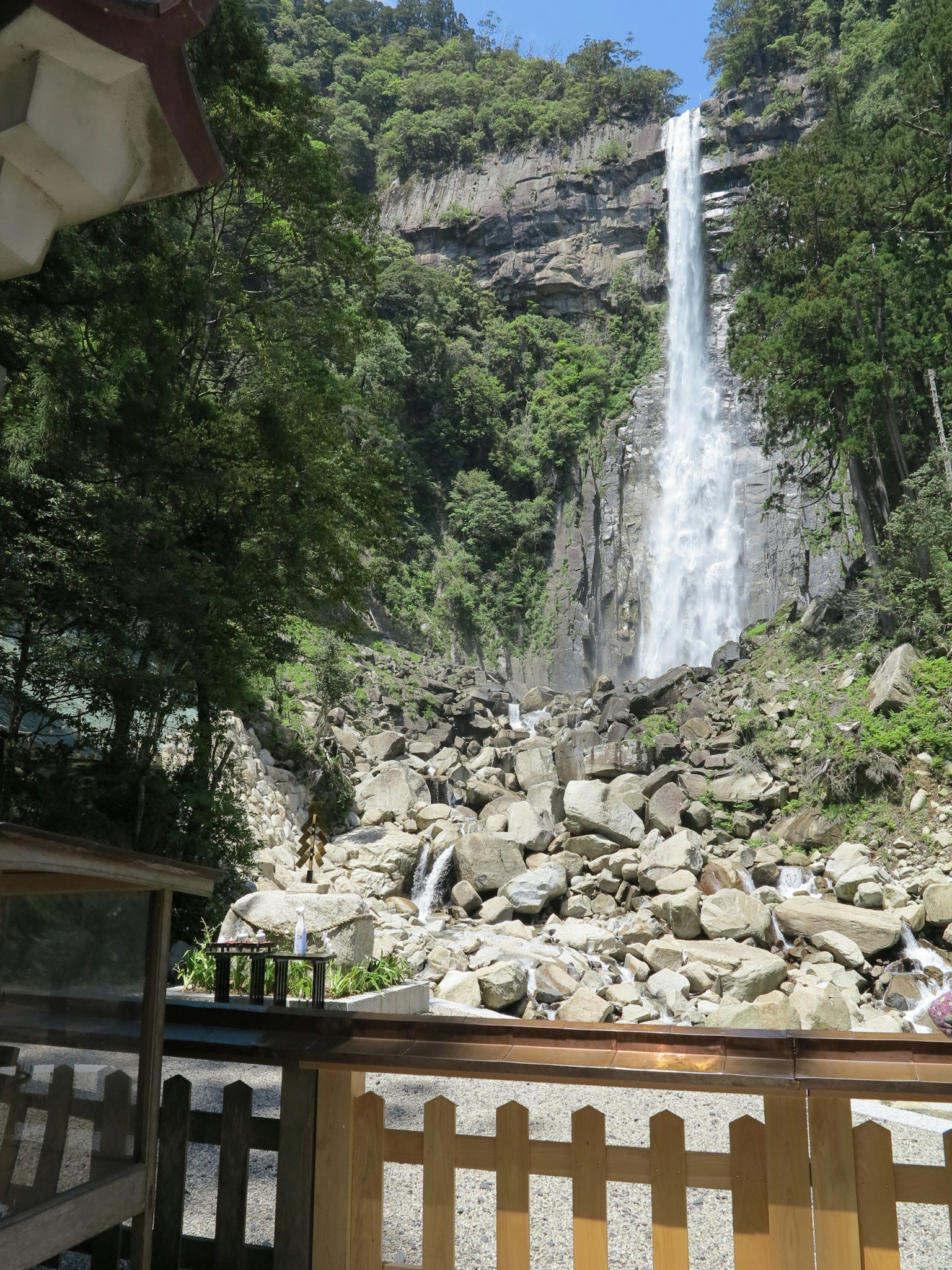 Scenic view of a waterfall surrounded by lush green mountains
