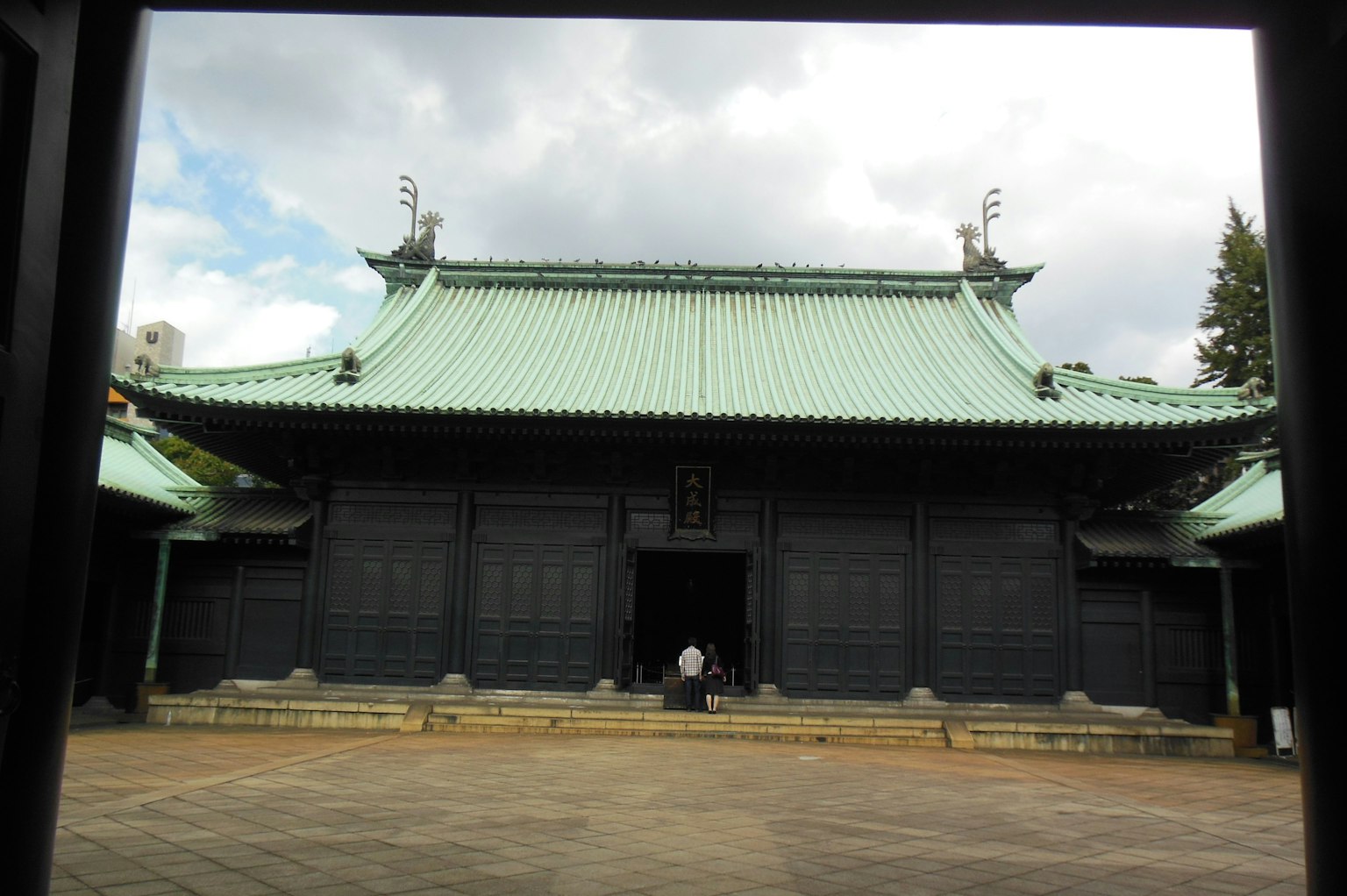 Exterior view of a traditional building with a green roof