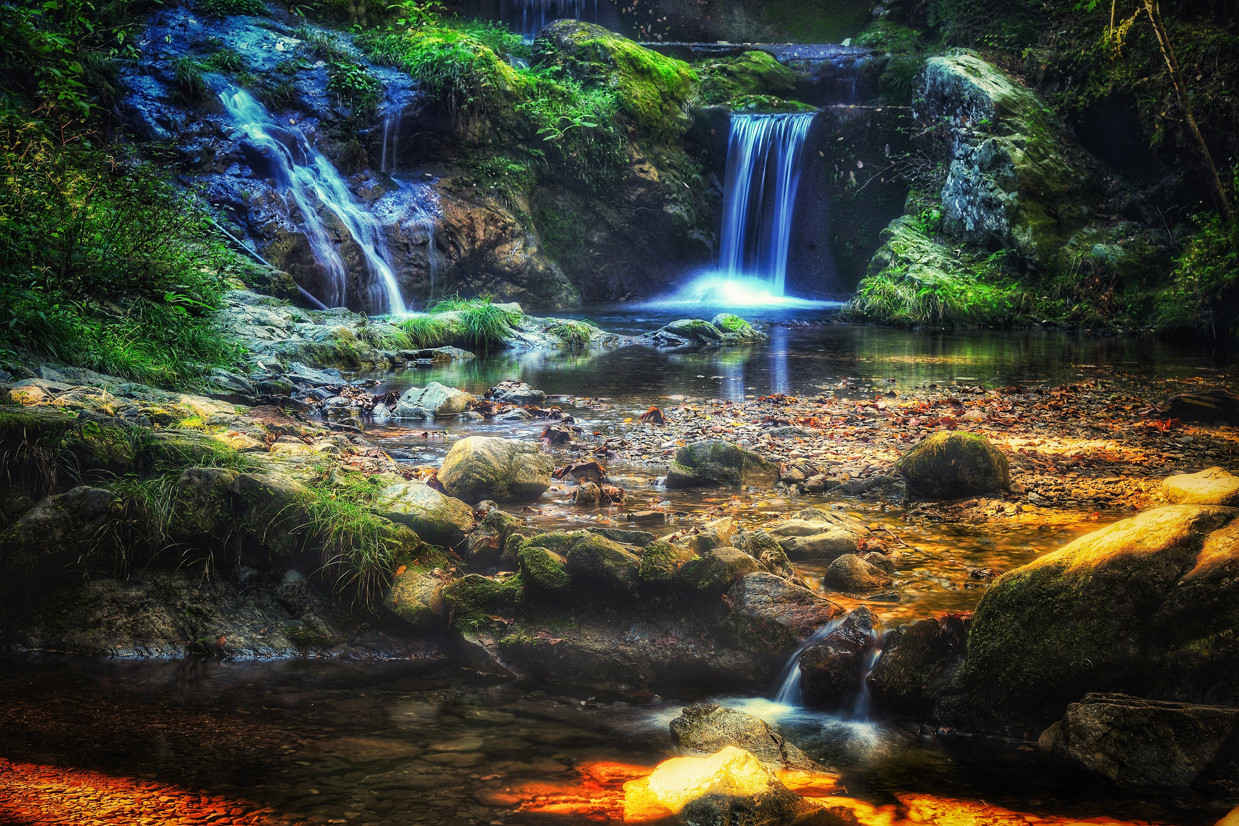 Rochers couverts de mousse et belle cascade se jetant dans un ruisseau