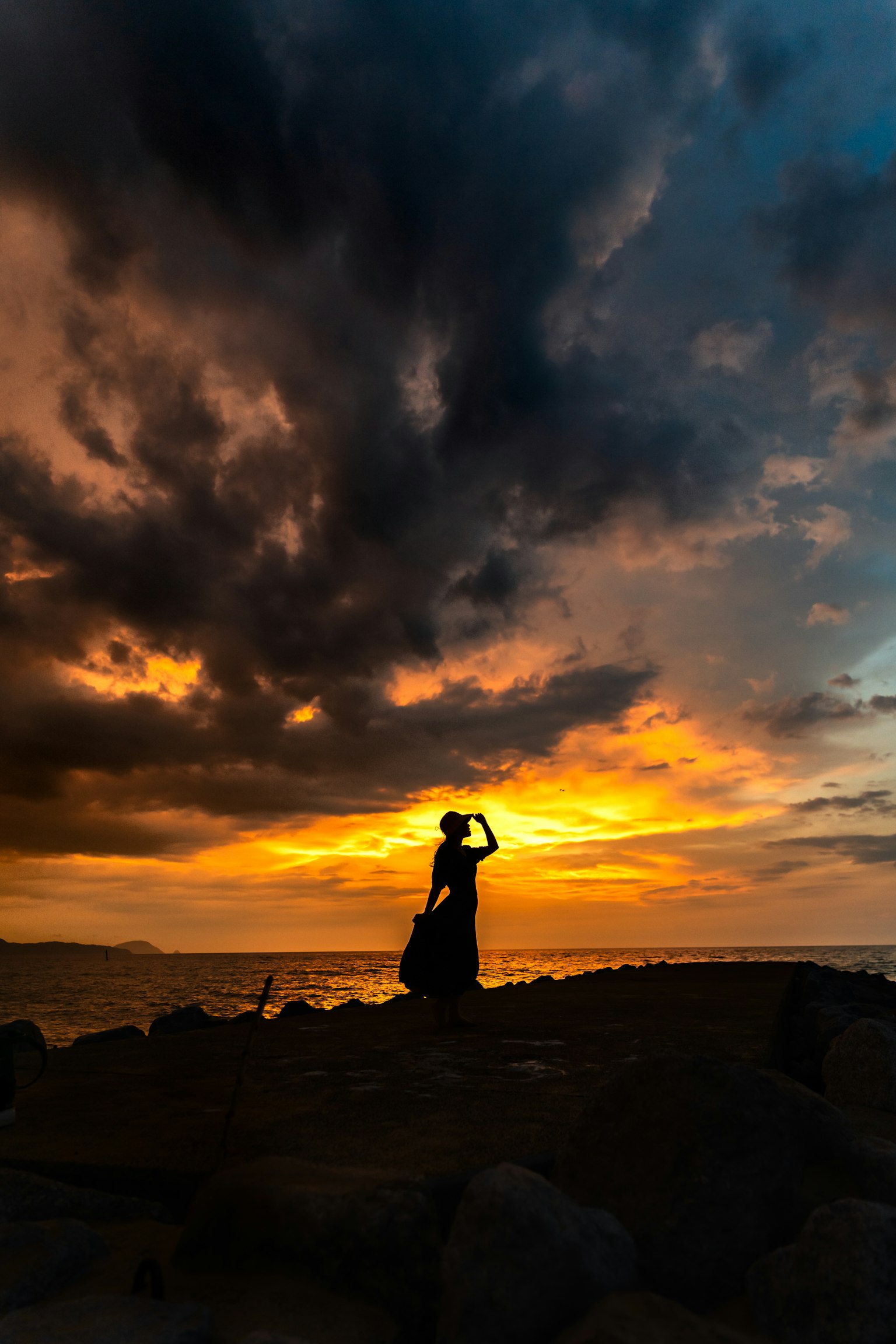 Silhouette of a woman posing against a beautiful sunset