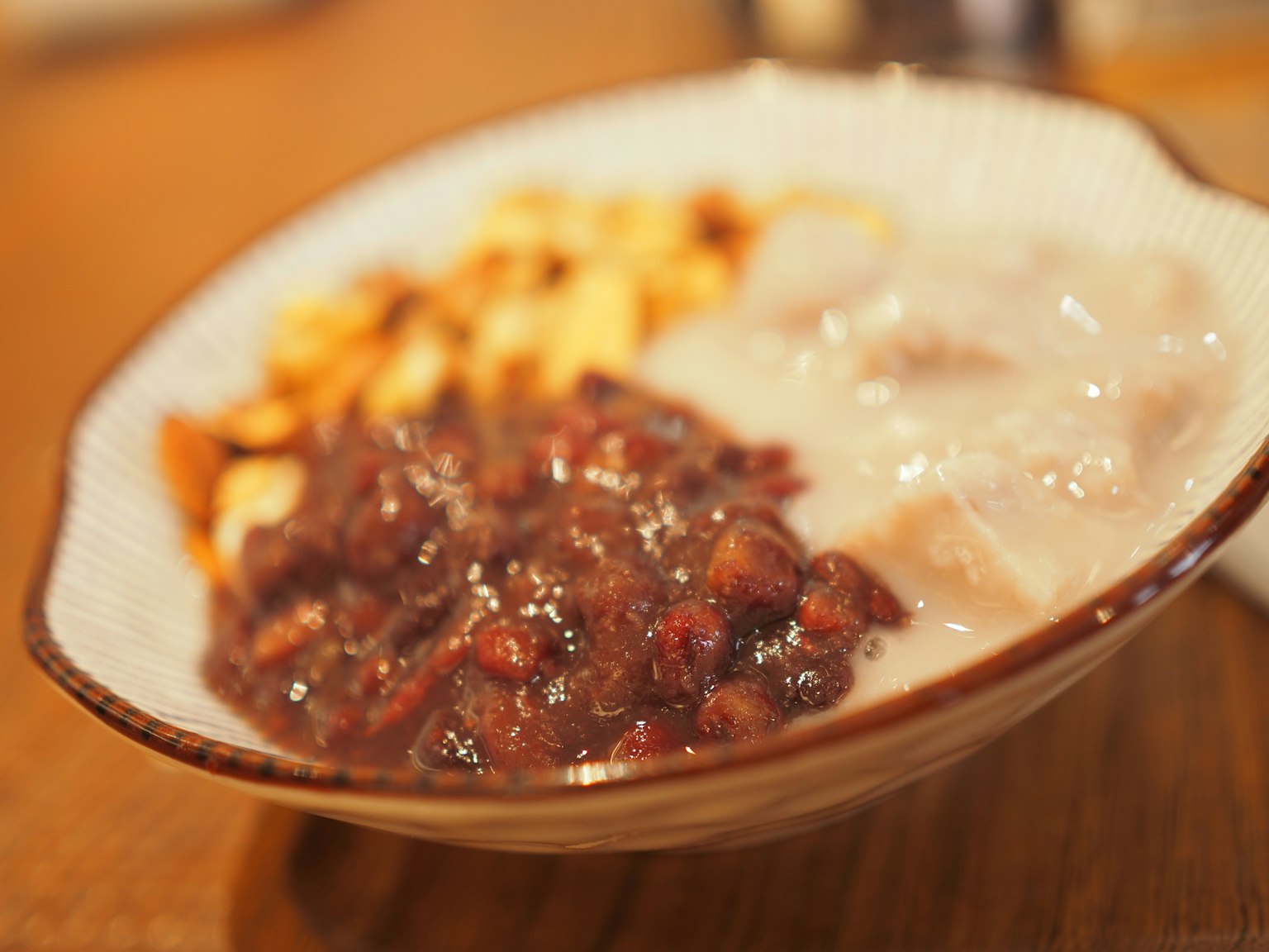 Bowl featuring sweet red bean paste creamy dessert and nuts