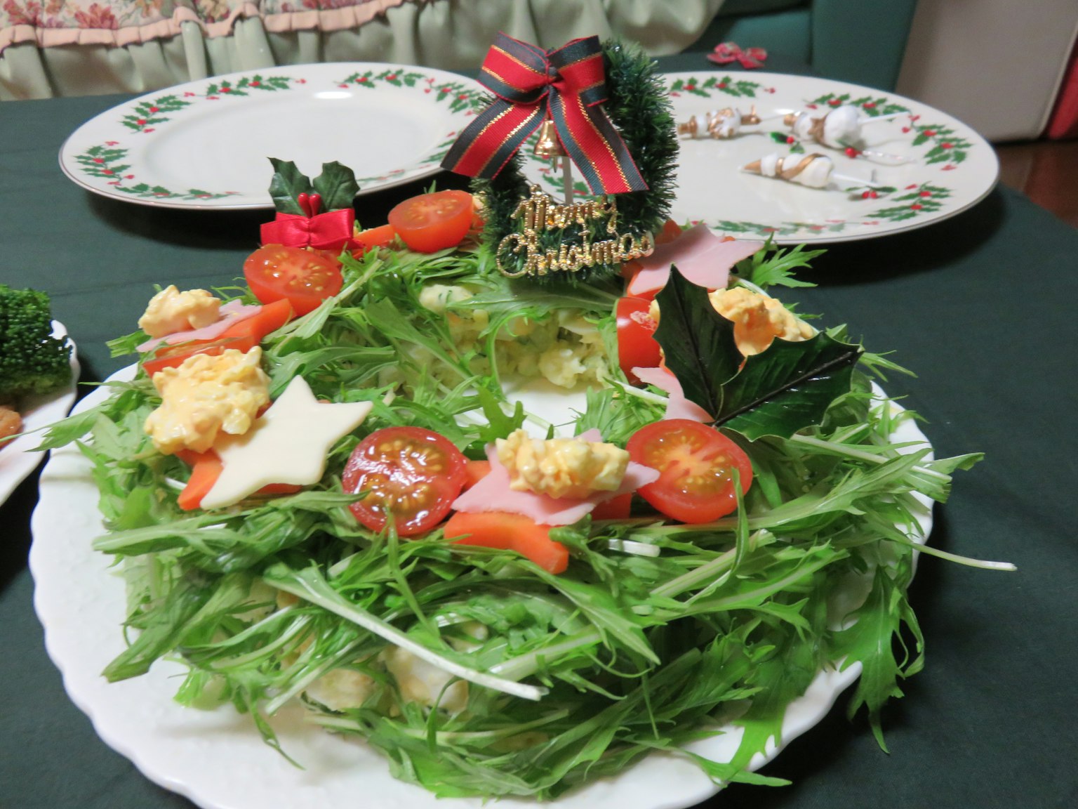 Salad yang dihias untuk Natal dengan sayuran segar dan tomat
