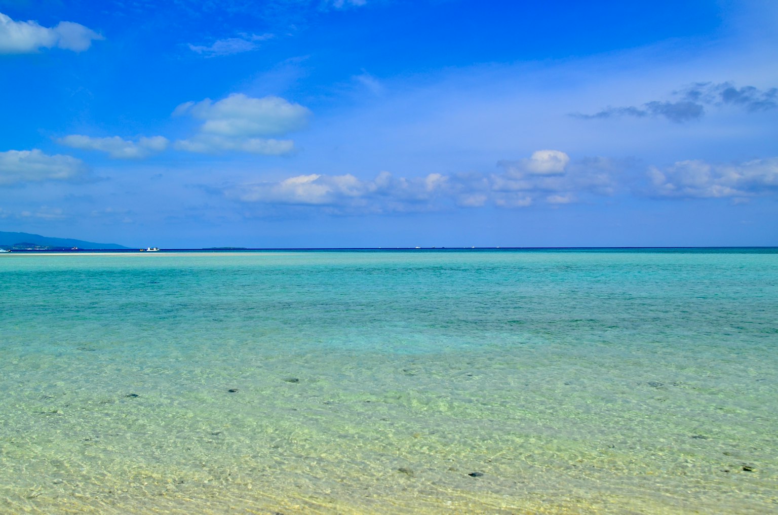 Scenic view of a clear blue sky and transparent ocean