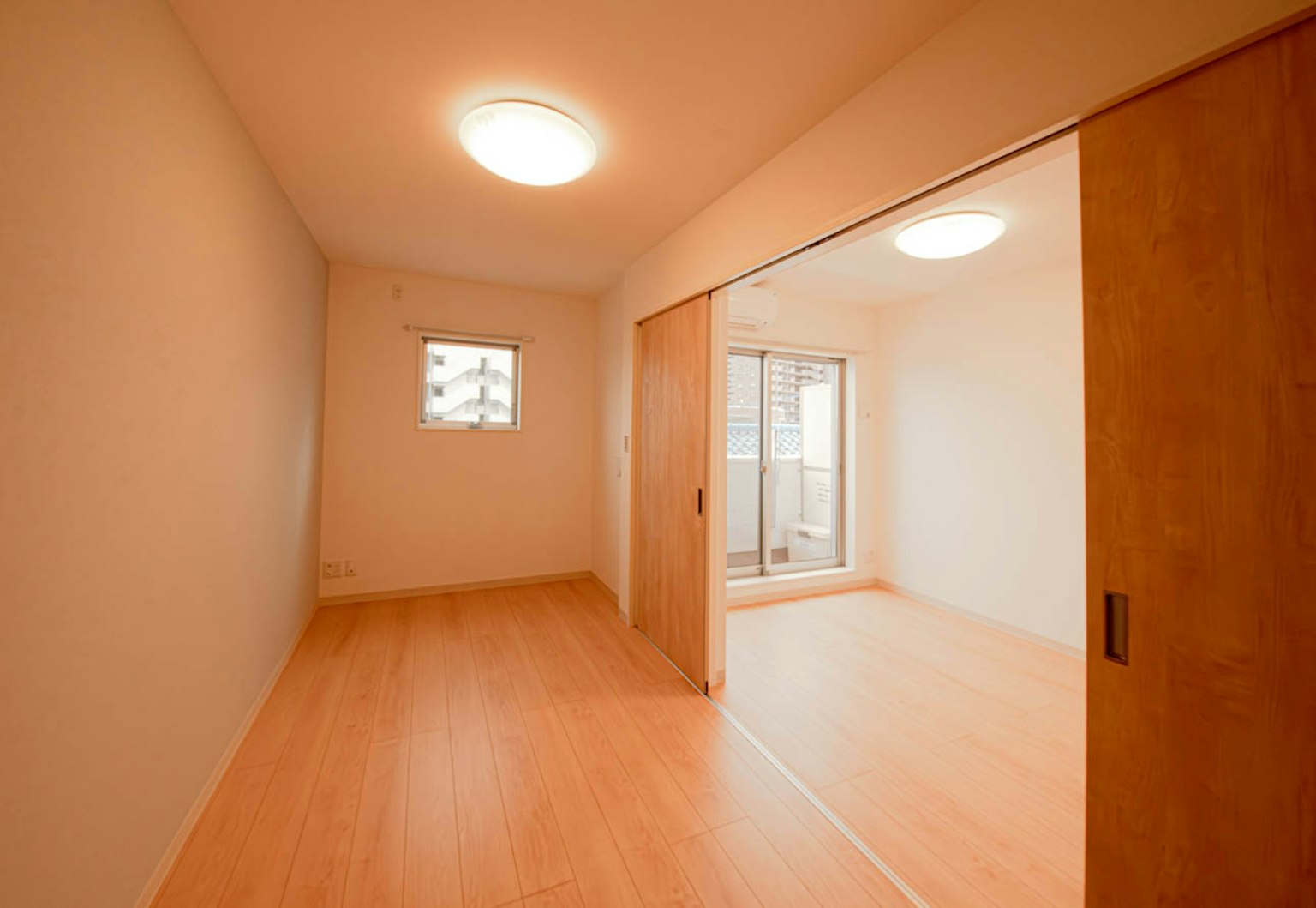 Bright interior space with a window wooden flooring and sliding doors