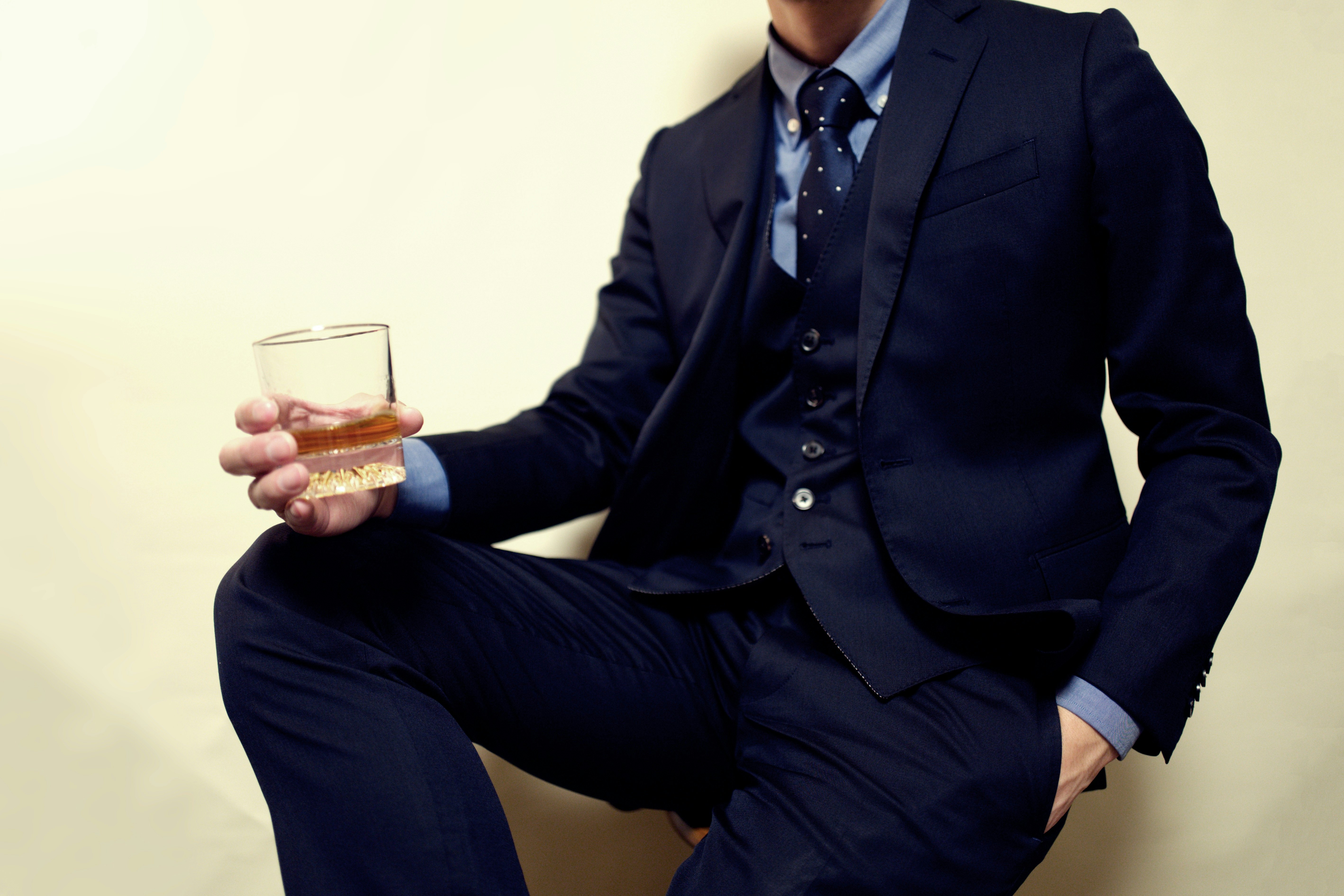 man in a suit holding a glass for a toast