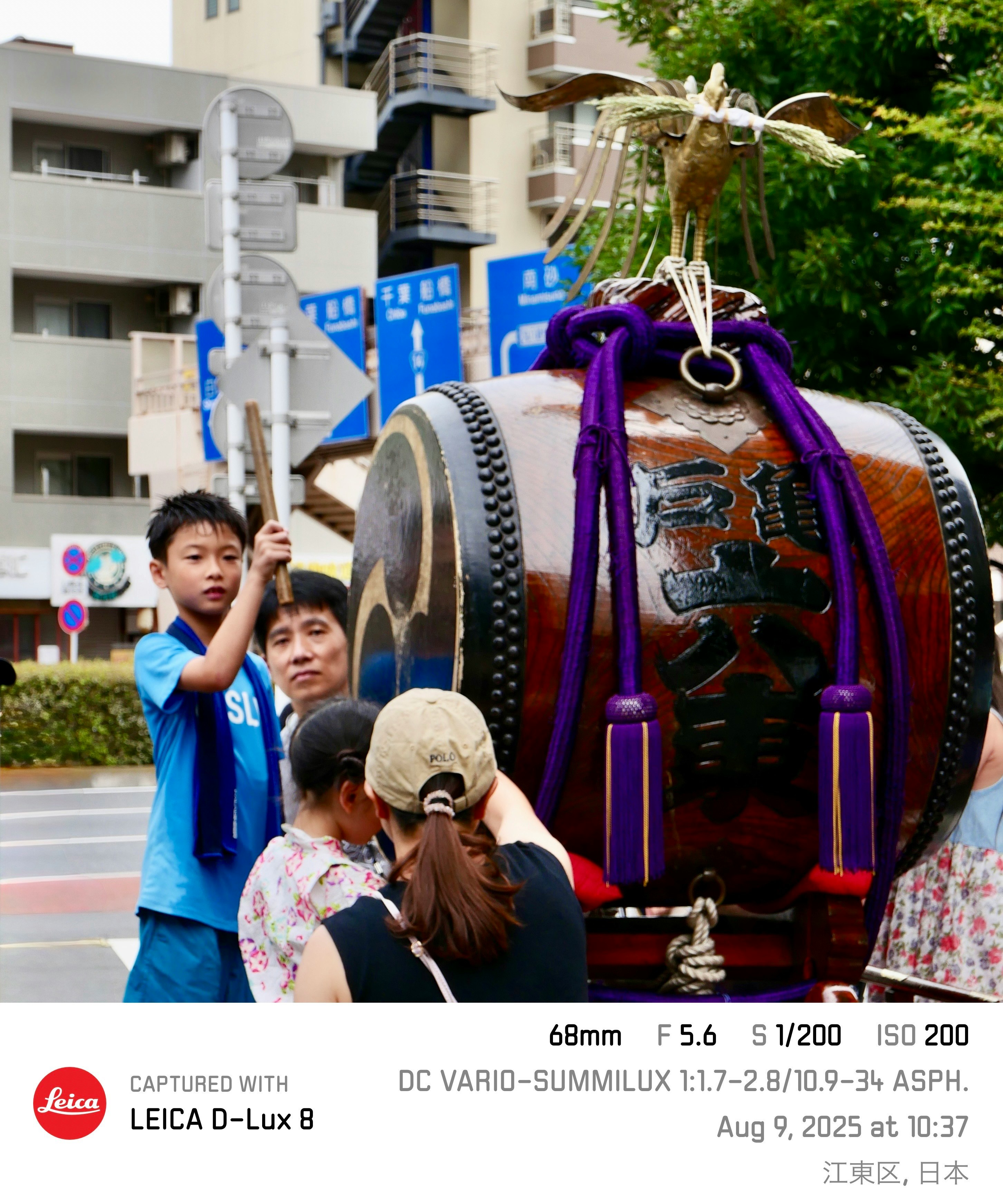 街头表演：背着大太鼓的鼓手与观看的孩子