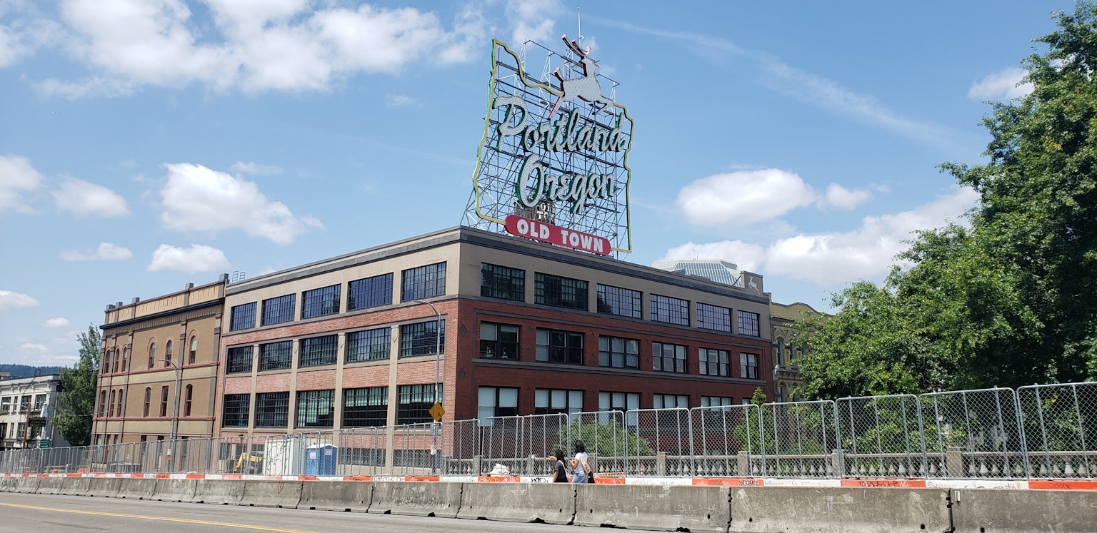 Retro brick building under blue sky with bright sign on top