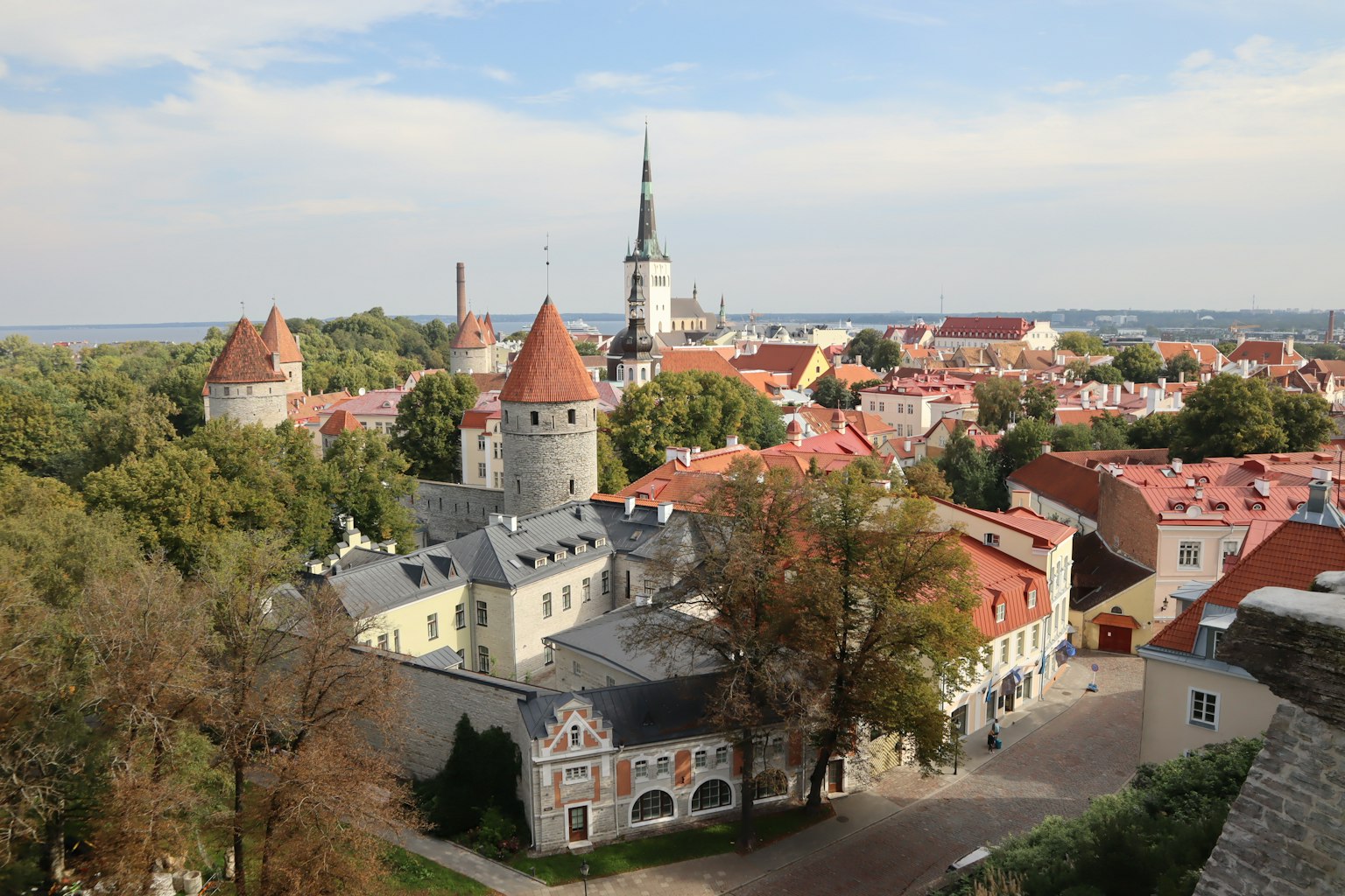 View of Tallinn's Old Town featuring medieval towers and red-roofed houses