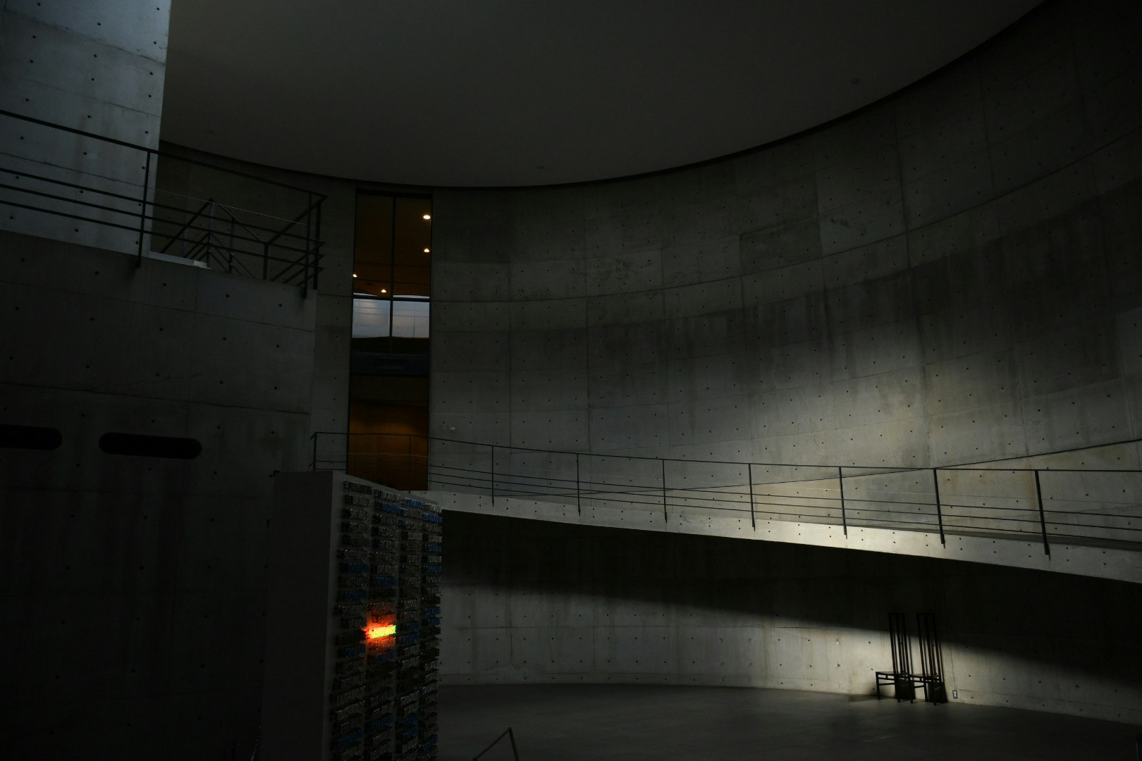 Dimly lit concrete tunnel corridor