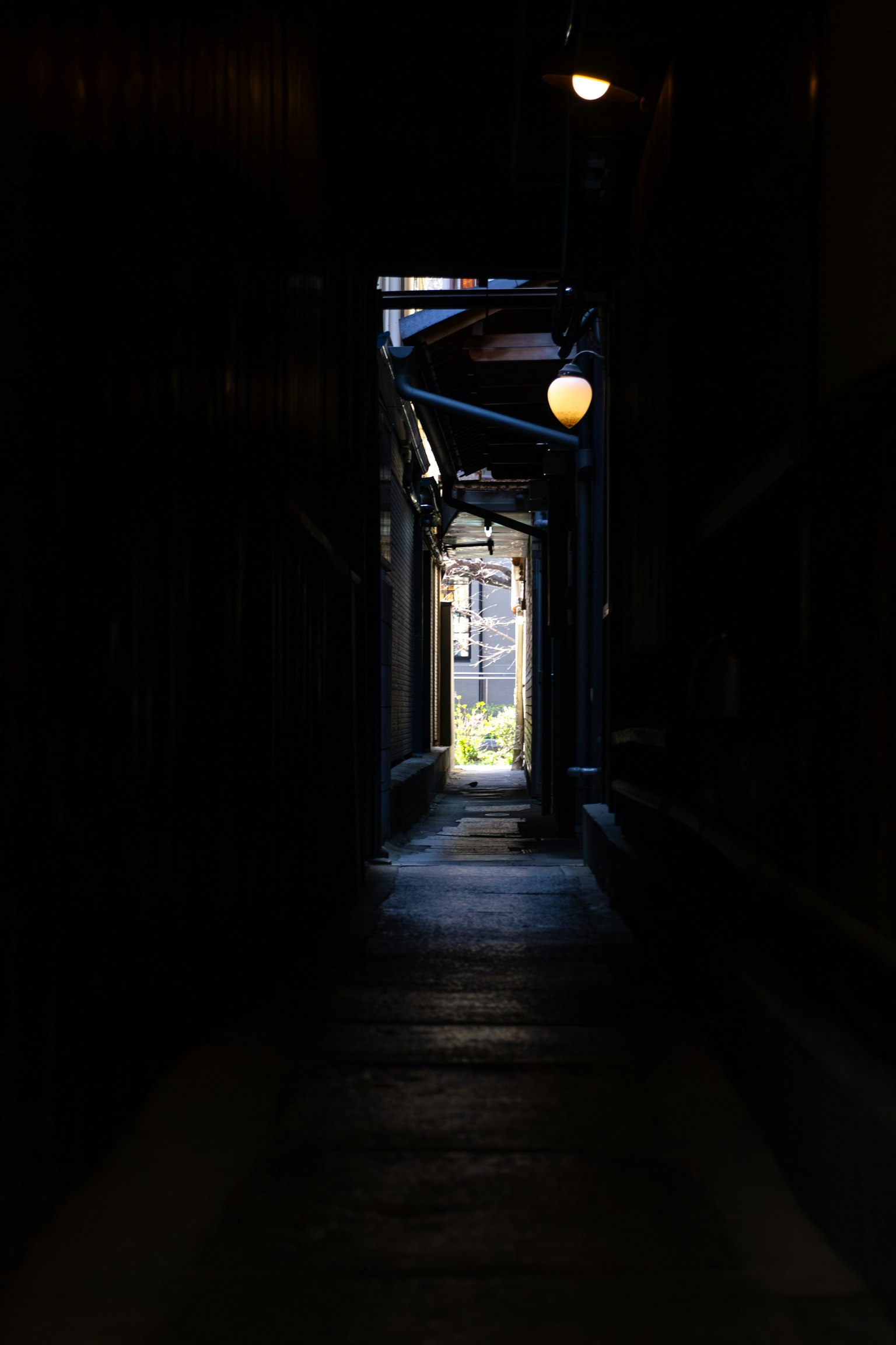 暗い路地の奥に明るい光が差し込む
