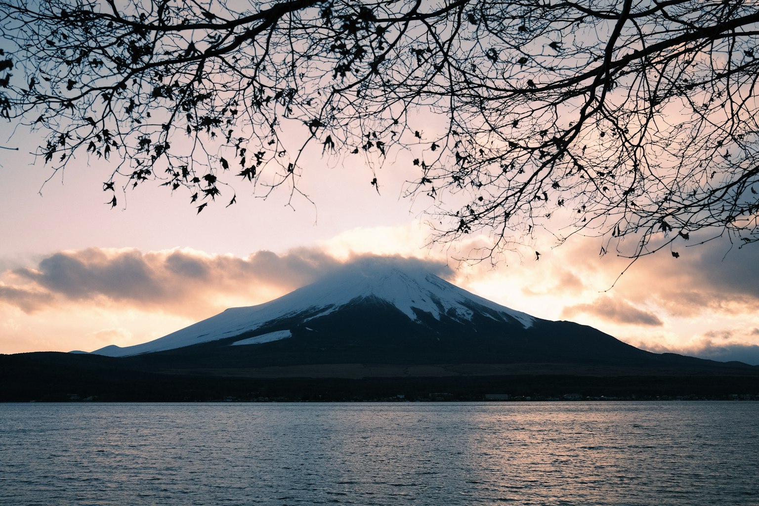Beautiful sunset view of Mount Fuji with tranquil lake surface