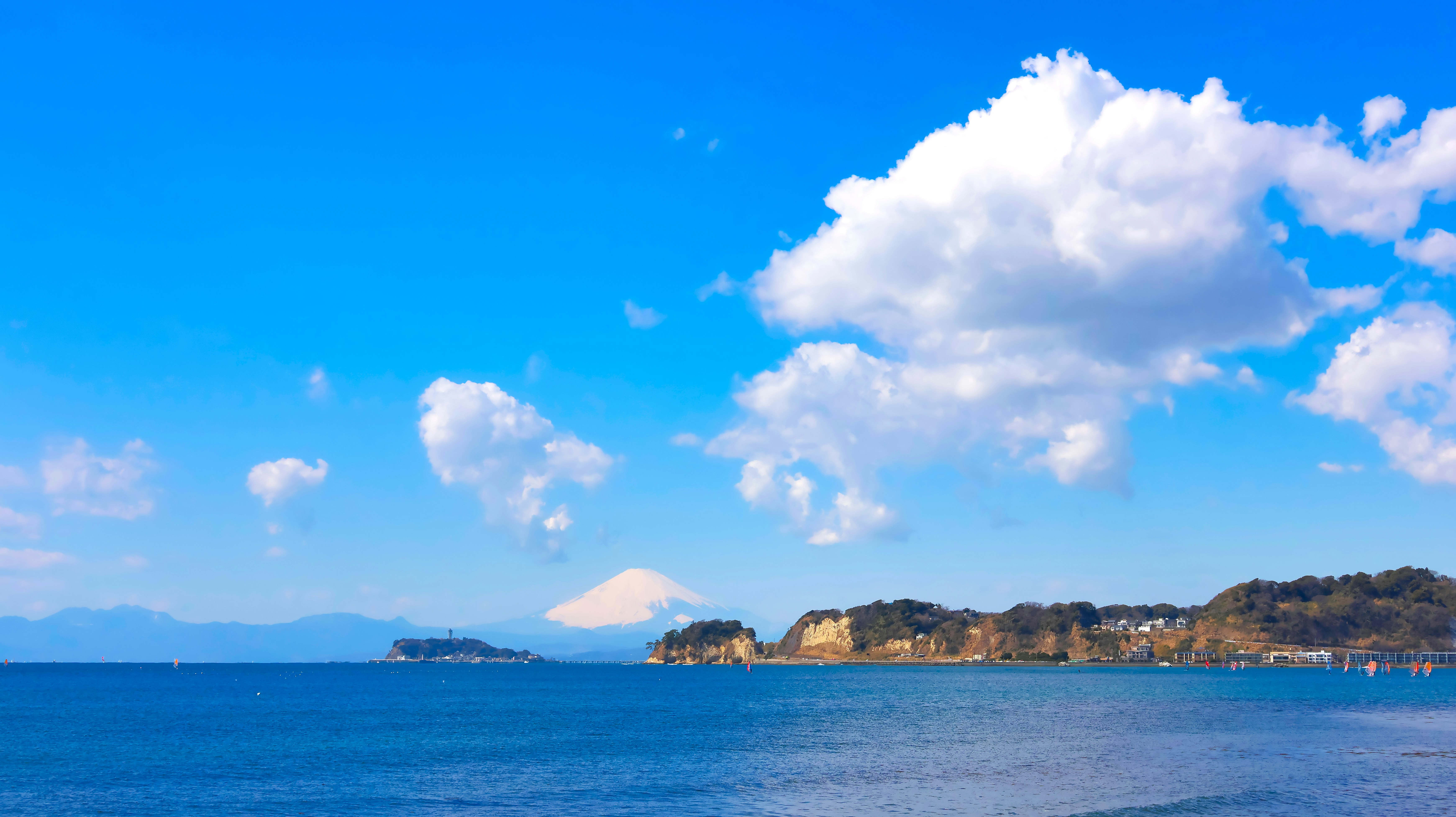 海辺の青空と遠くの山、水平線の景色