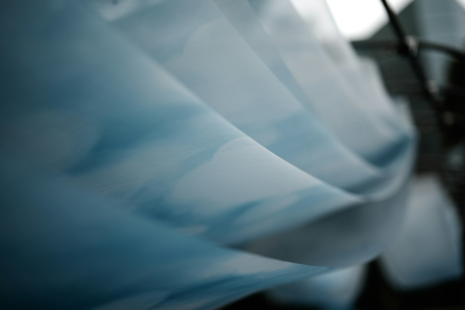 Abstract image featuring smooth blue curves and textures