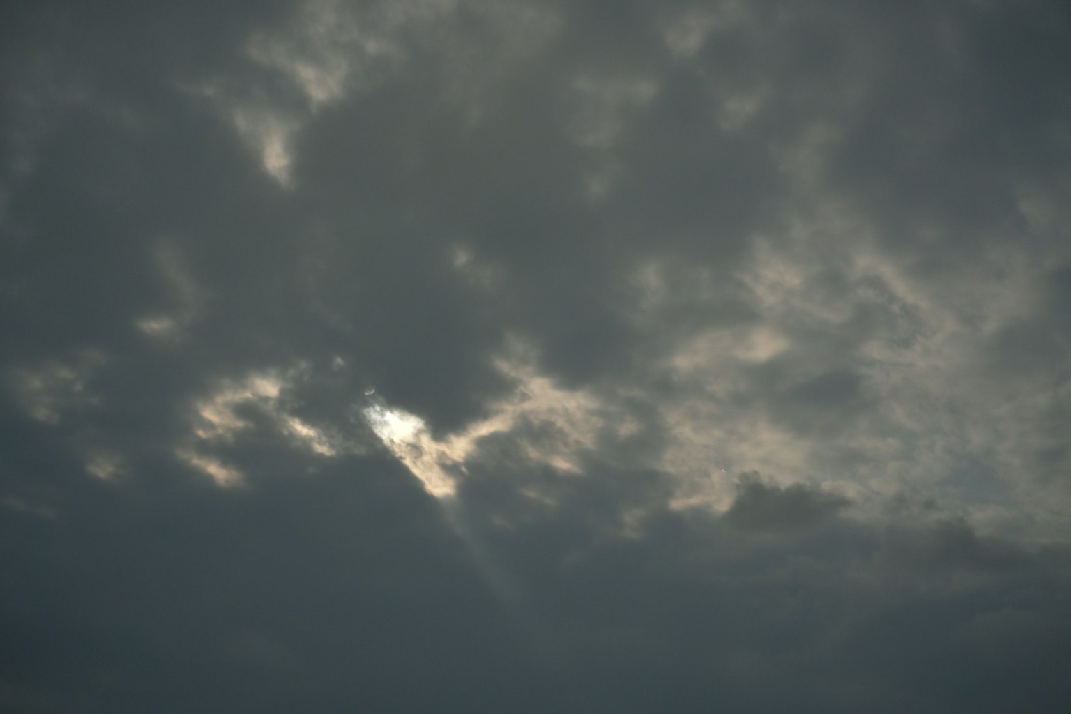 Sky with dark clouds and rays of light breaking through