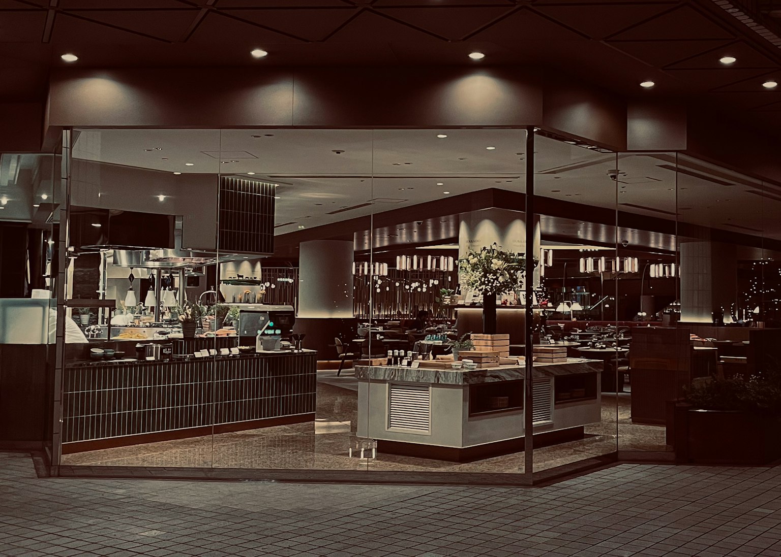 Modern cafe interior design featuring glass walls and wooden decor