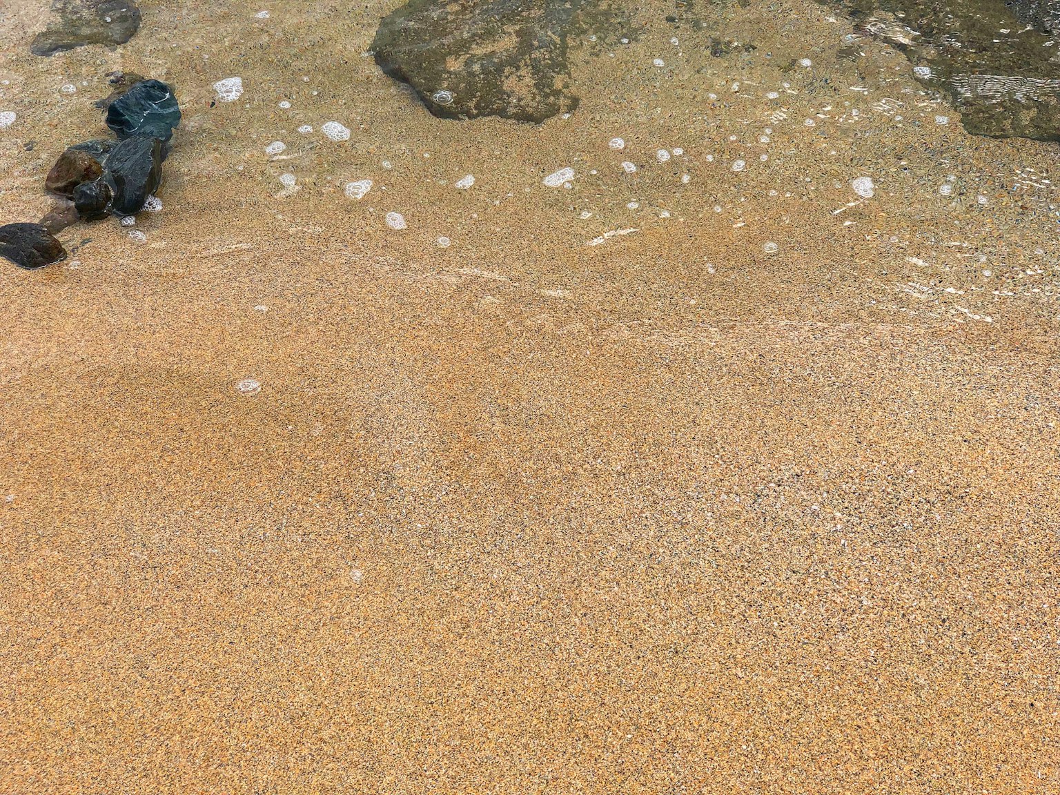 Strandszene mit Sand und Felsen