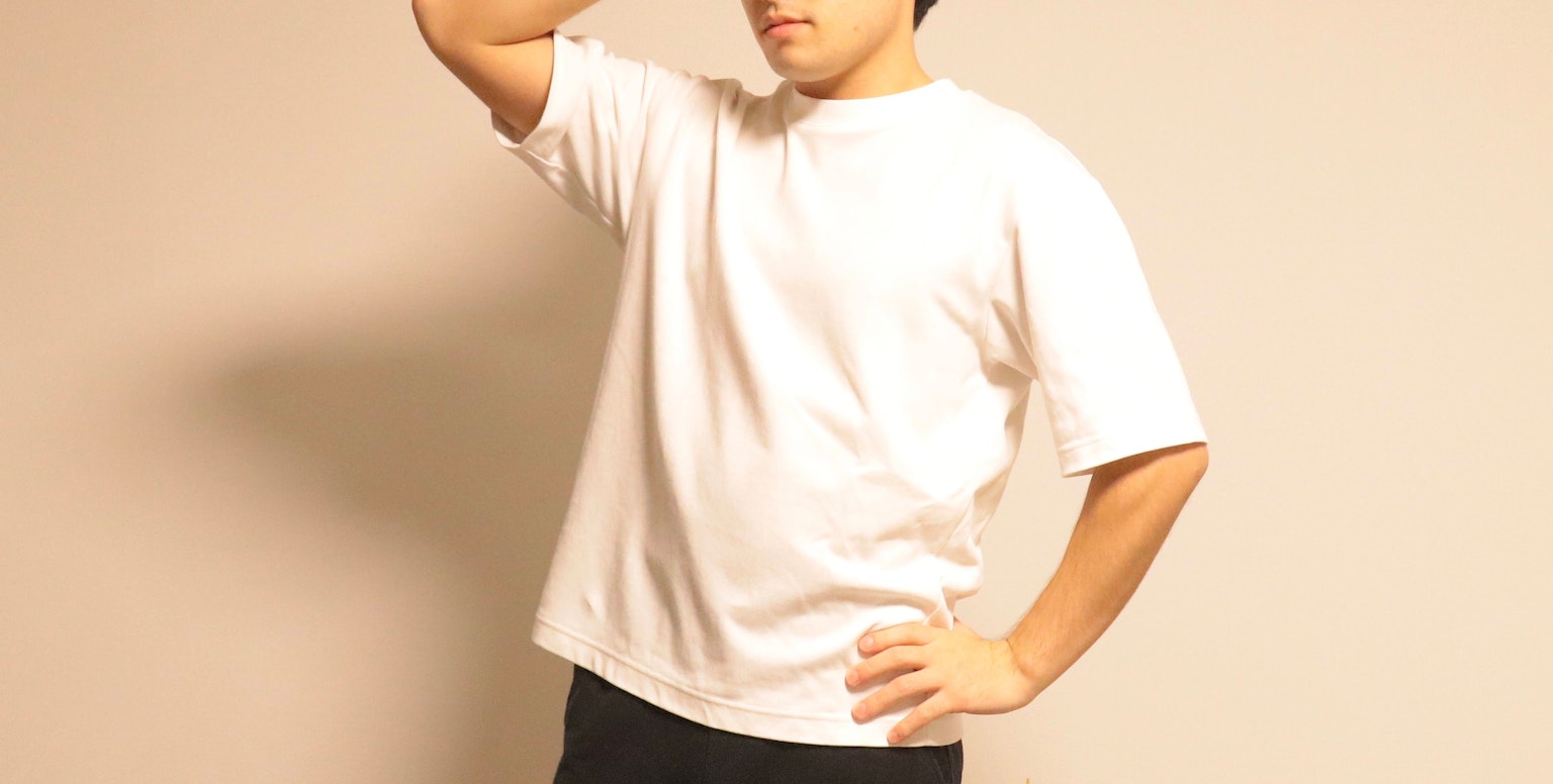 Man posing in a white t-shirt with a neutral background