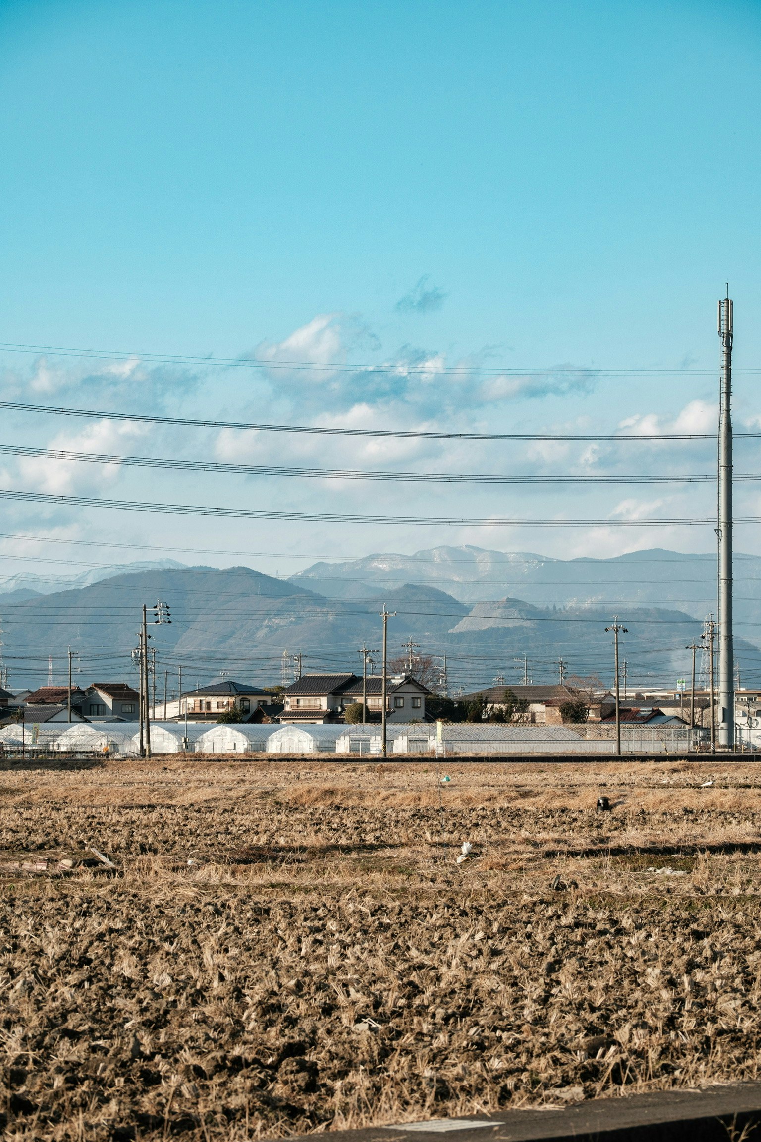 Rural landscape with mountains under a blue sky and clouds