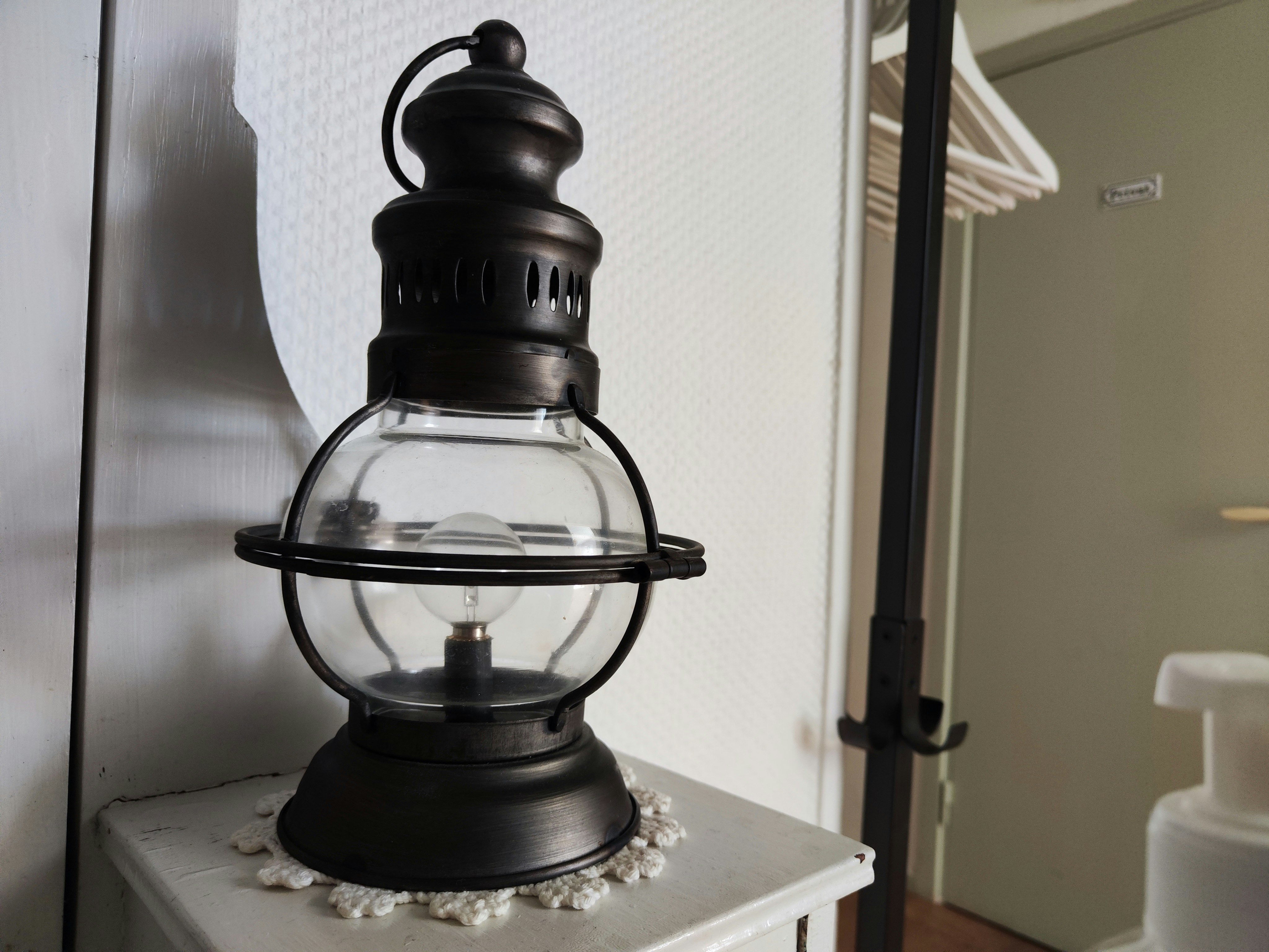 lantern-style light on an indoor shelf