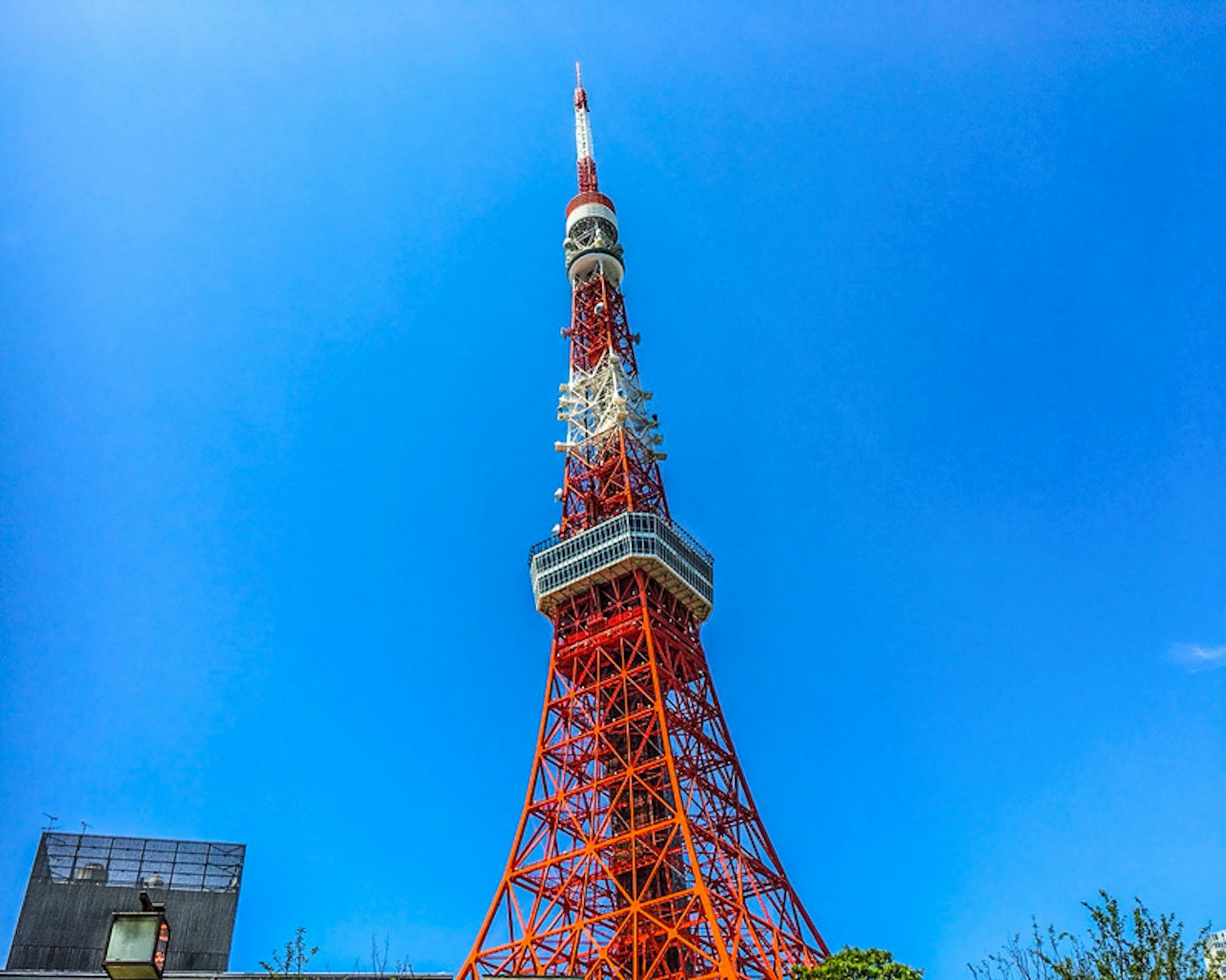 Tokyo Tower with vibrant orange structure against a clear blue sky