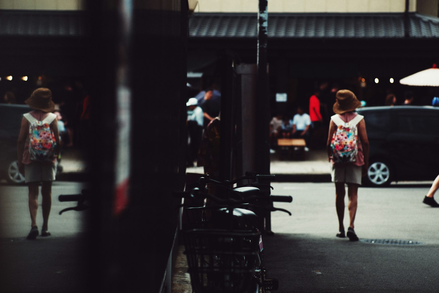 A woman walking in the street with a backpack
