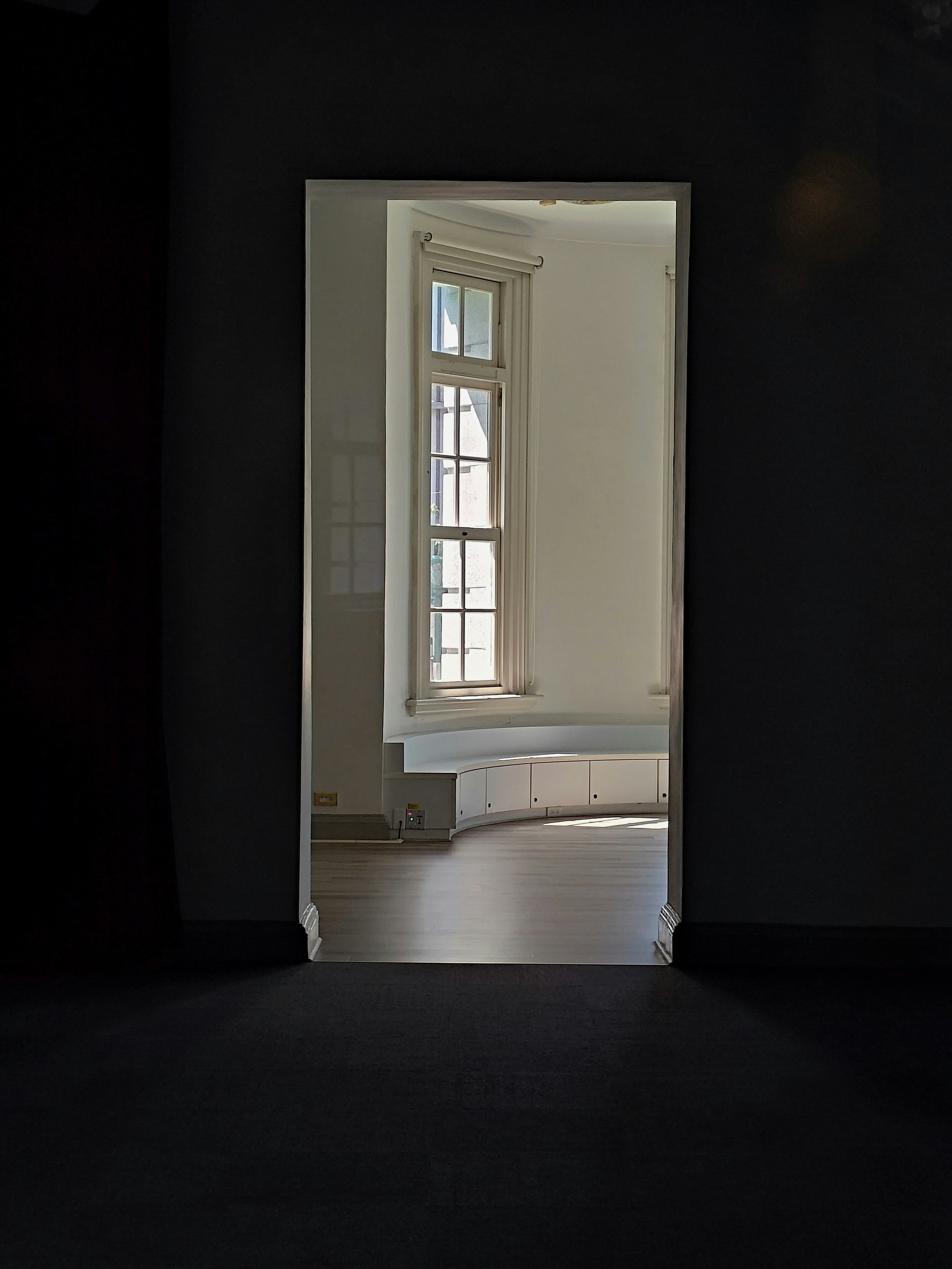 faint window light spilling from a dark interior doorway