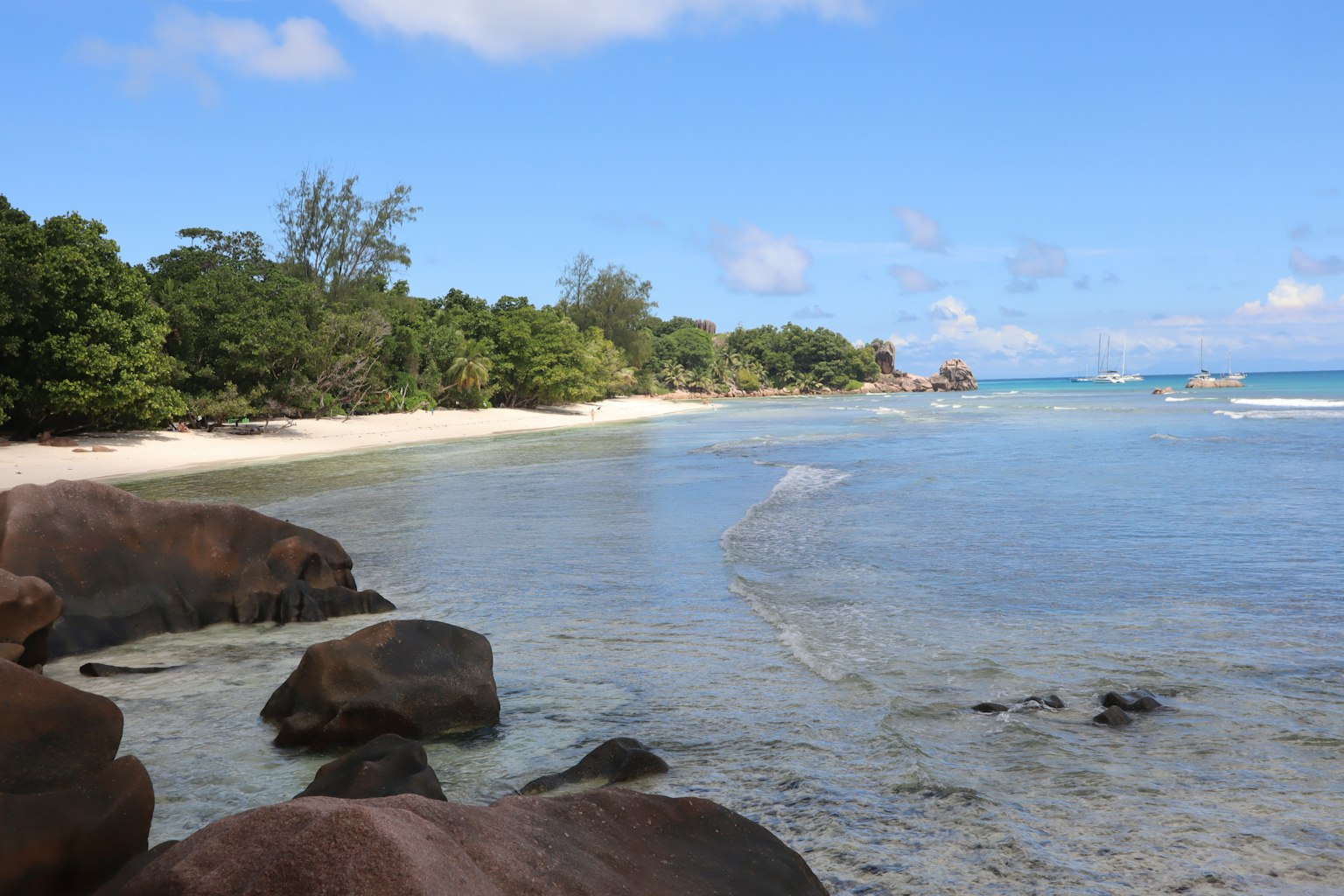 Scenic beach view with blue water and white sand