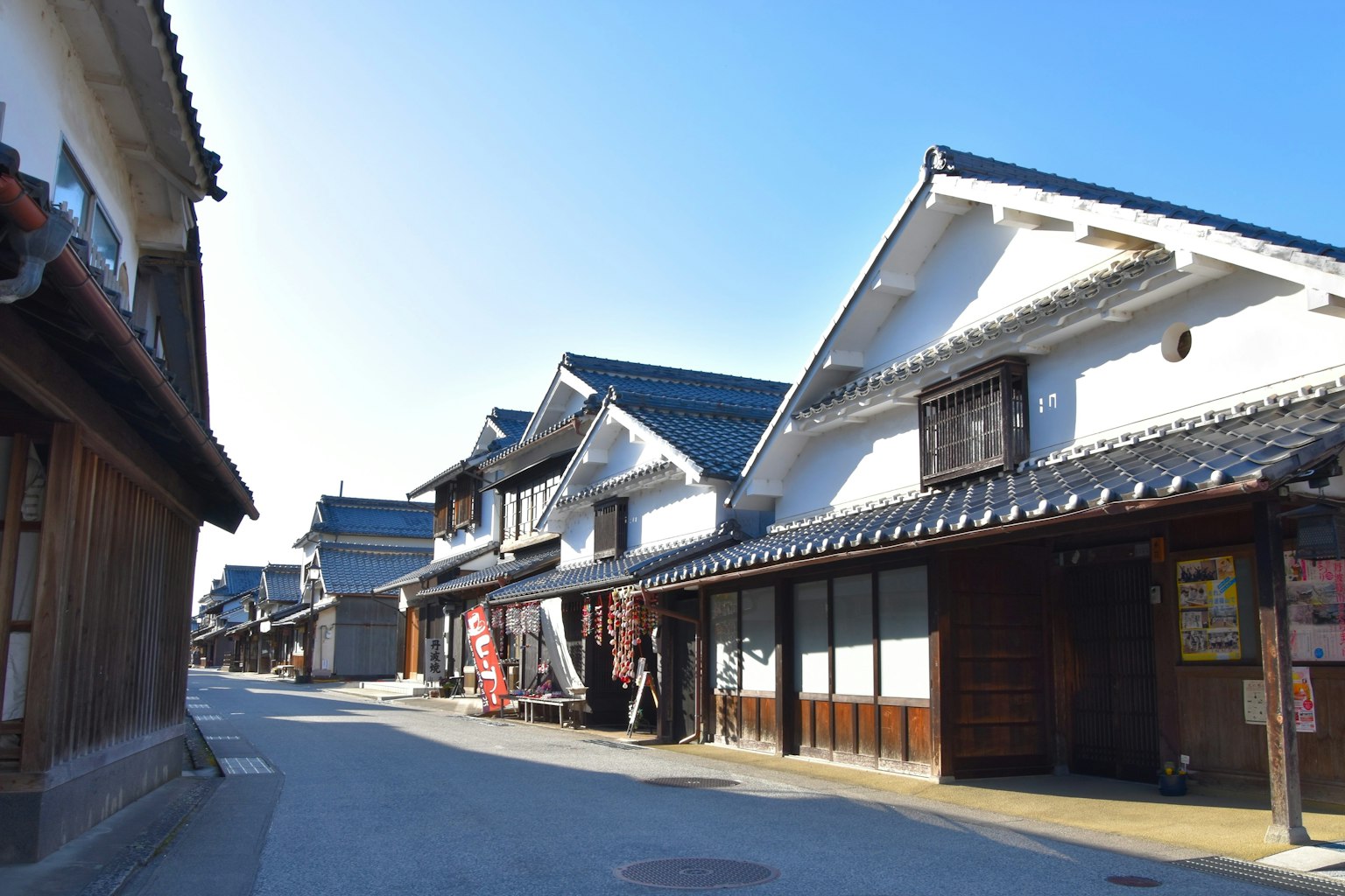 Traditional Japanese street view featuring old houses along a quiet road