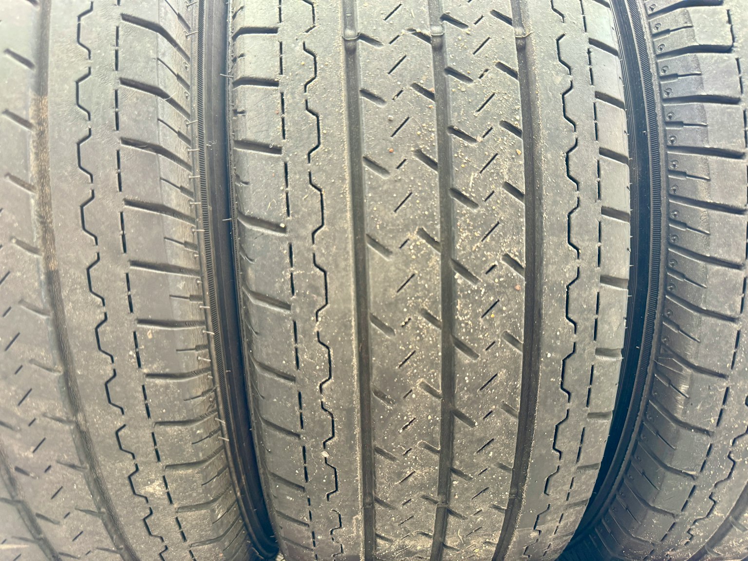 Three tires lined up showcasing tread patterns