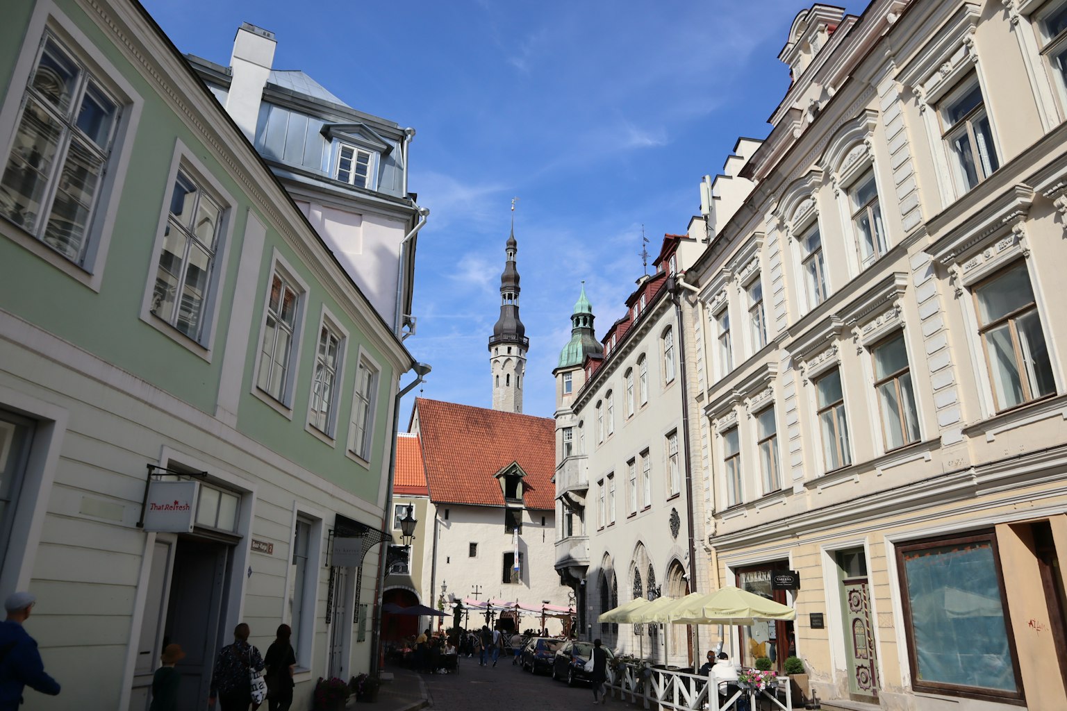 Narrow street in Tallinn's Old Town with historic buildings and blue sky